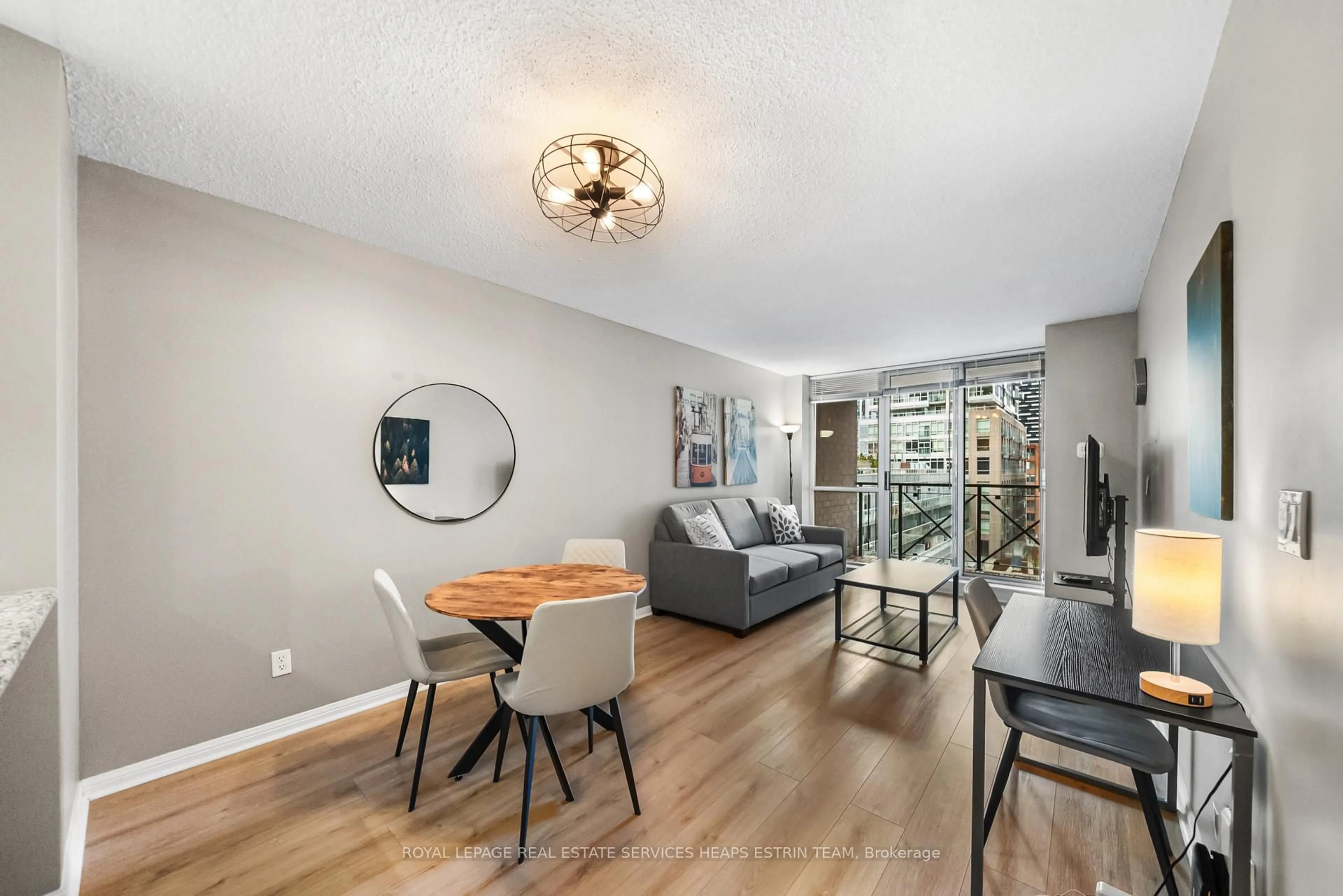 Living room with furniture, wood/laminate floor for 140 Simcoe St #702, Toronto Ontario M5H 4E9