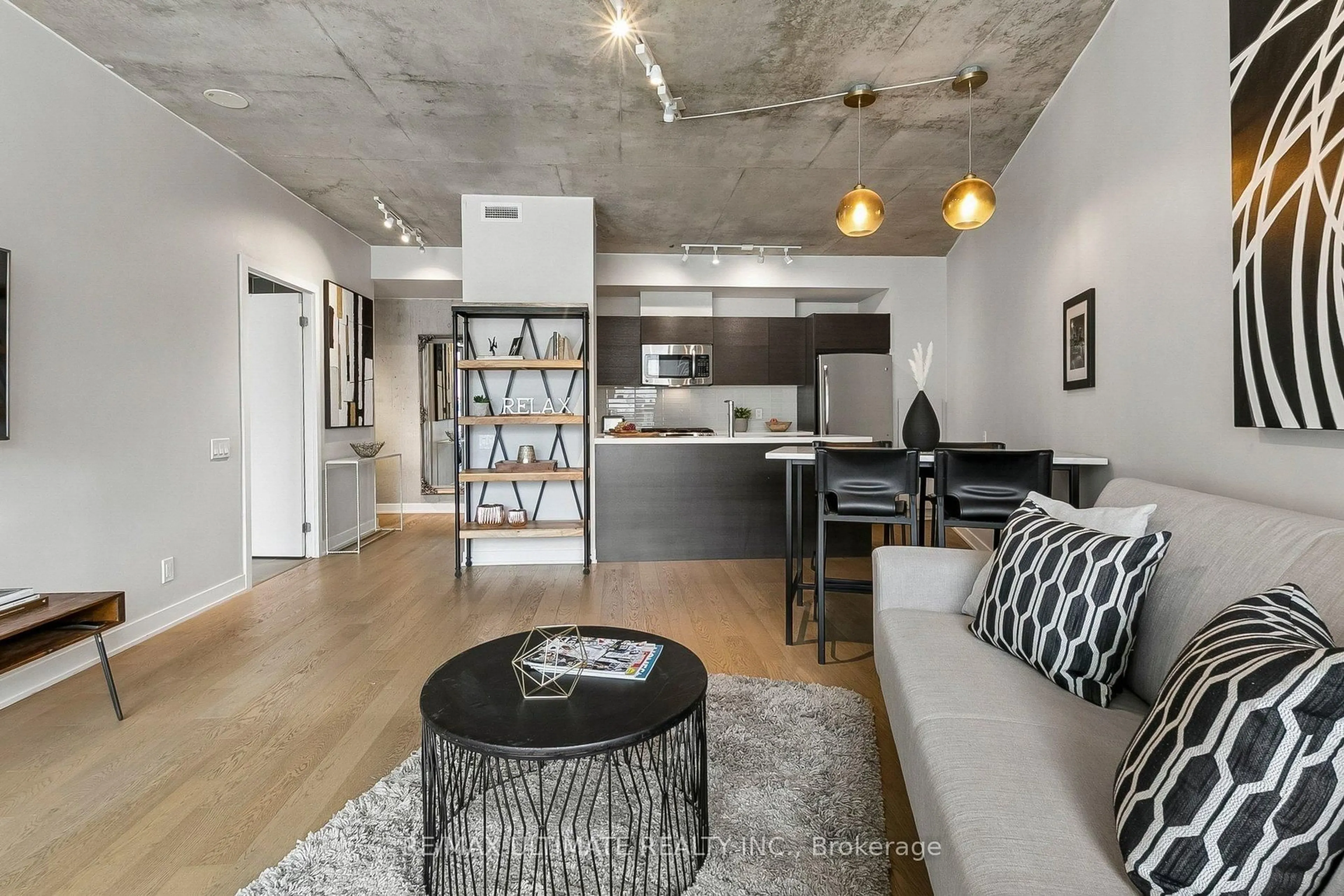 Living room with furniture, cement floor for 318 King St #217, Toronto Ontario M5A 1K6