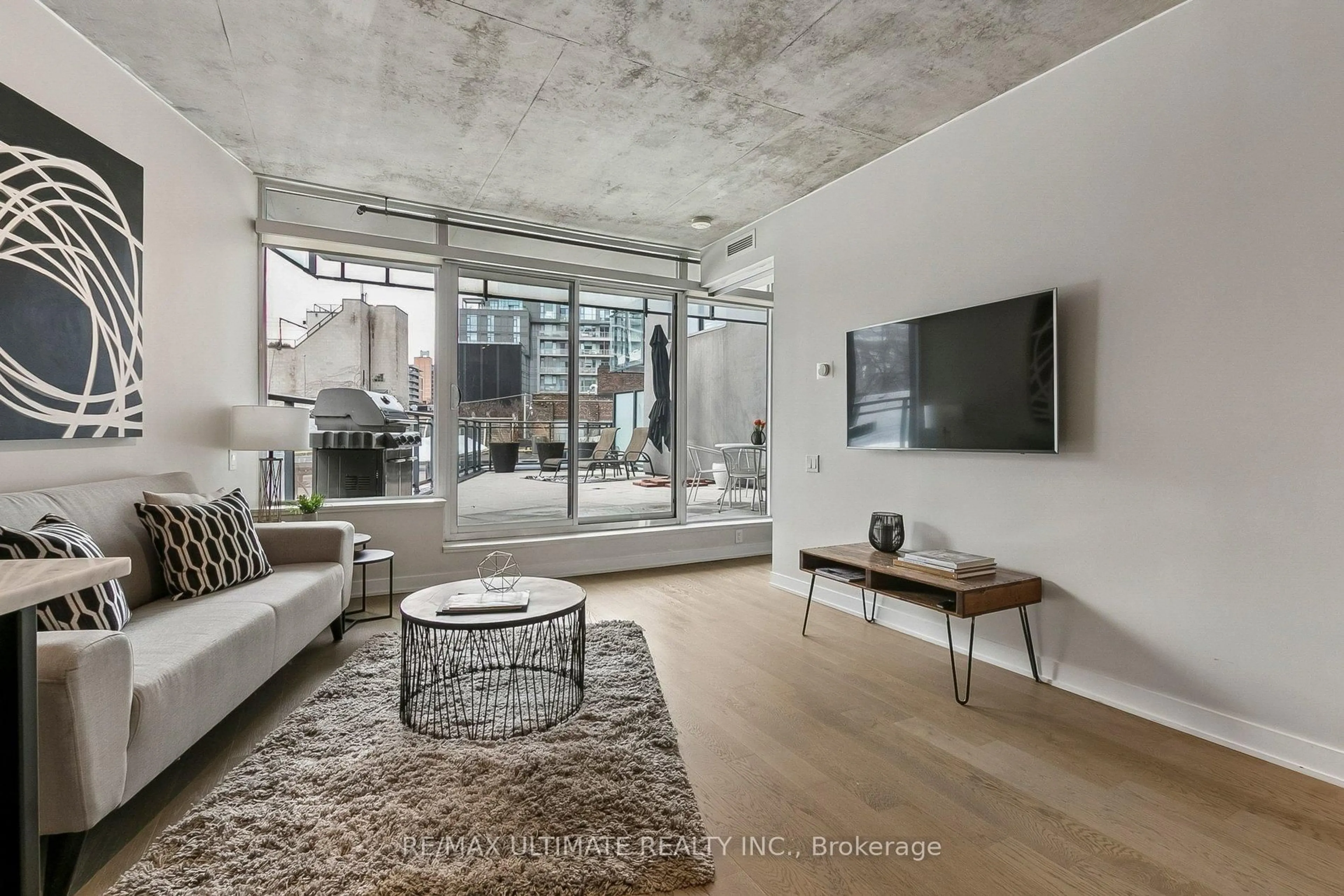 Living room with furniture, cement floor for 318 King St #217, Toronto Ontario M5A 1K6