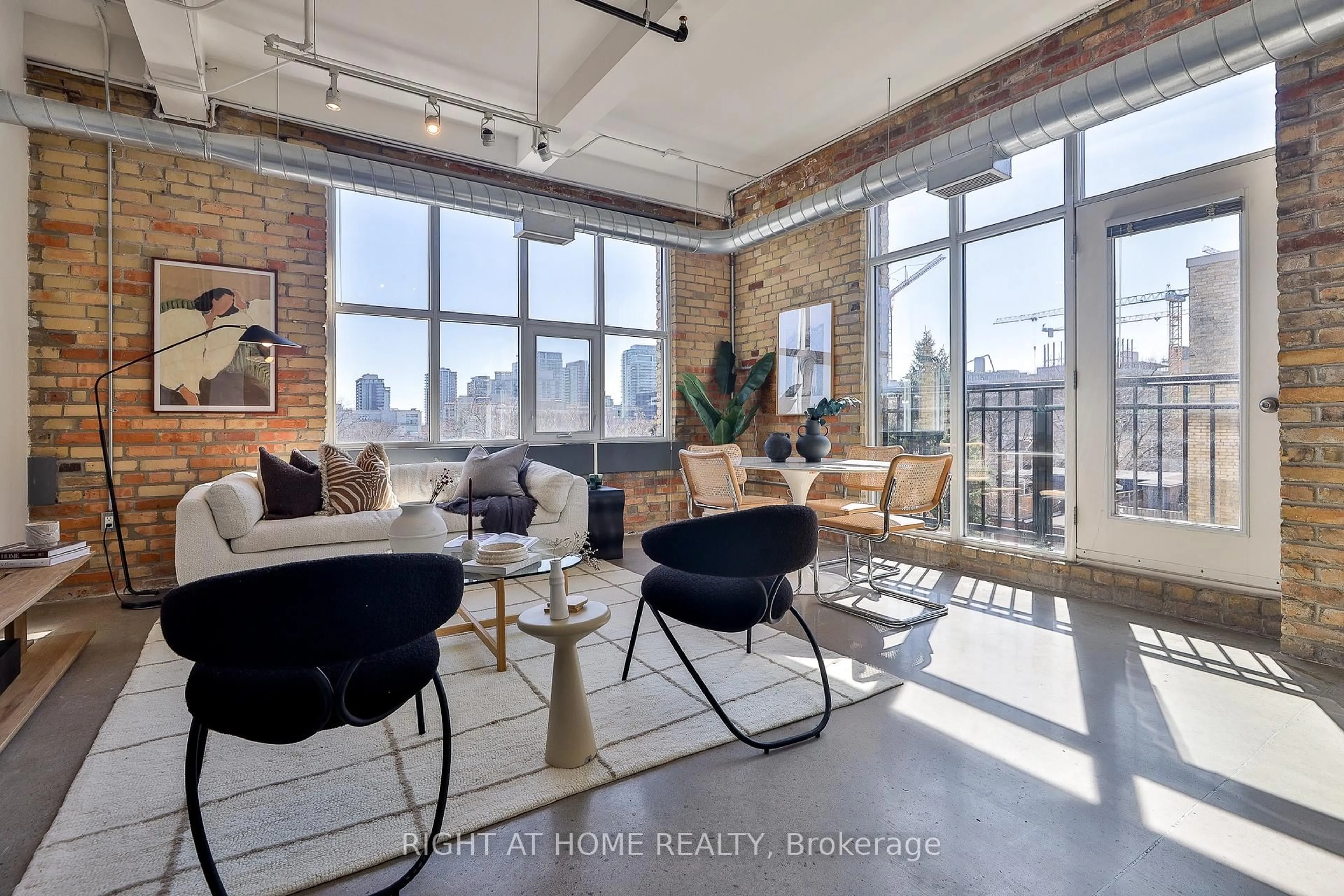 Living room with furniture, cement floor for 955 Queen St #519, Toronto Ontario M6J 3X5