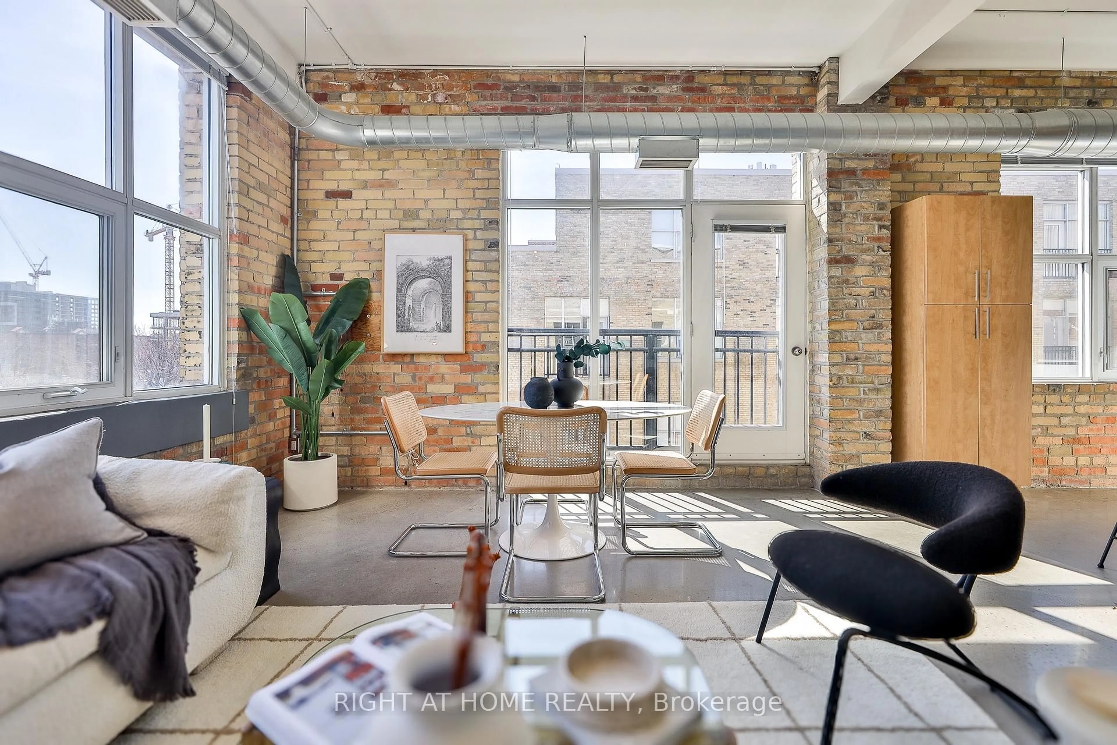 Living room with furniture, cement floor for 955 Queen St #519, Toronto Ontario M6J 3X5