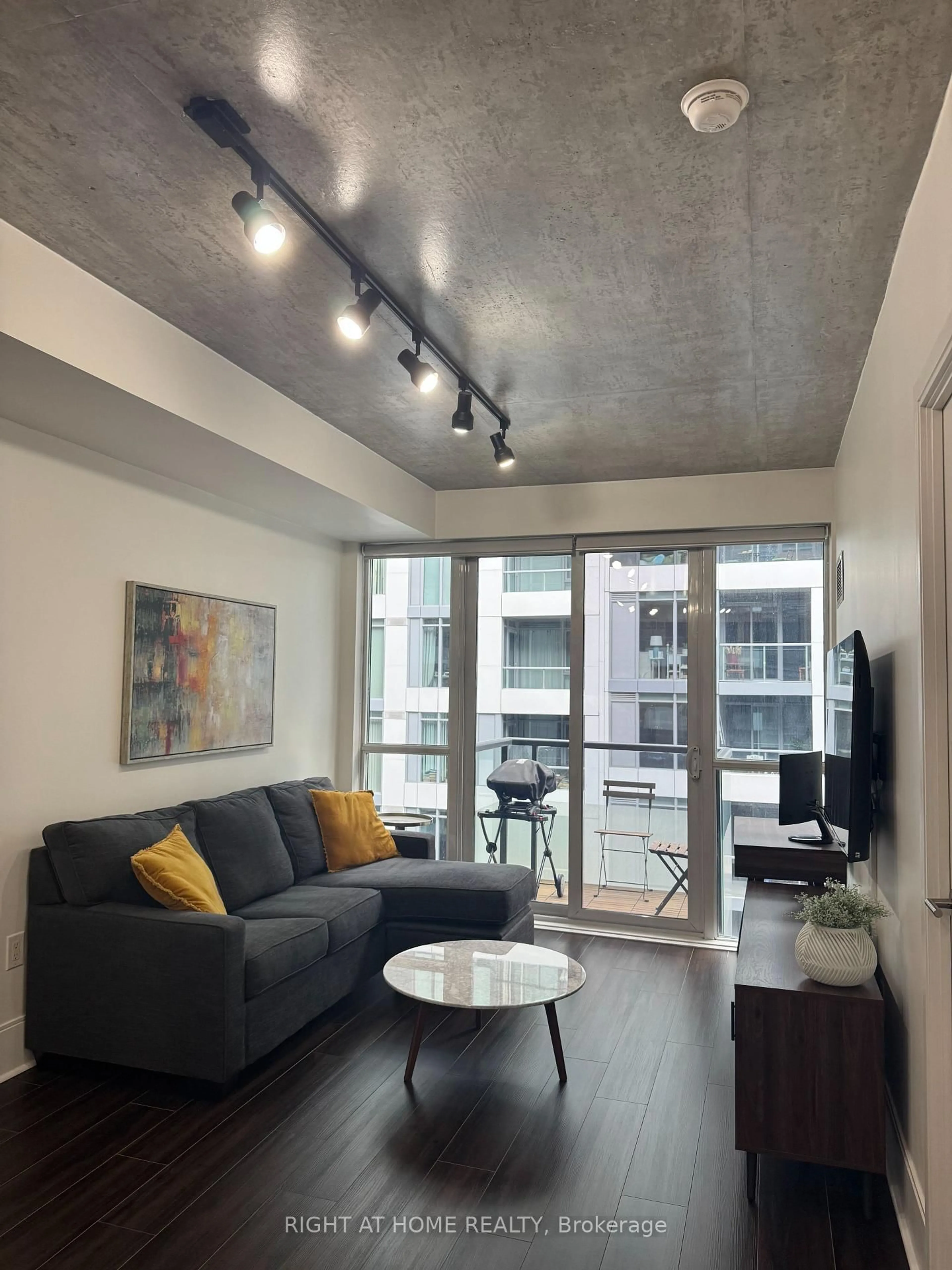 Living room with furniture, cement floor for 560 Front Street West St #708, Toronto Ontario M5V 1C1