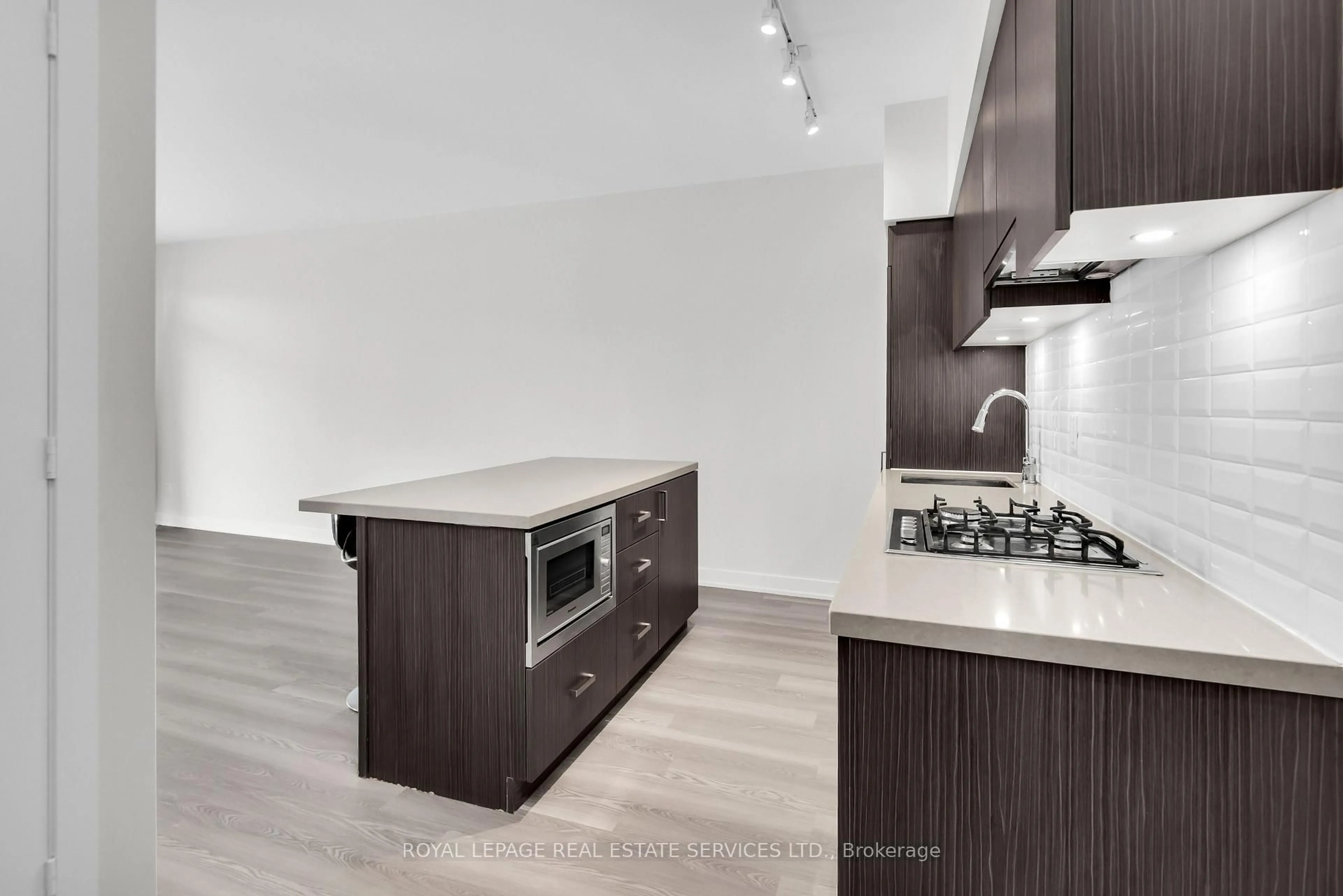 Open concept kitchen, wood/laminate floor for 501 St Clair Ave #1104, Toronto Ontario M5P 0A2