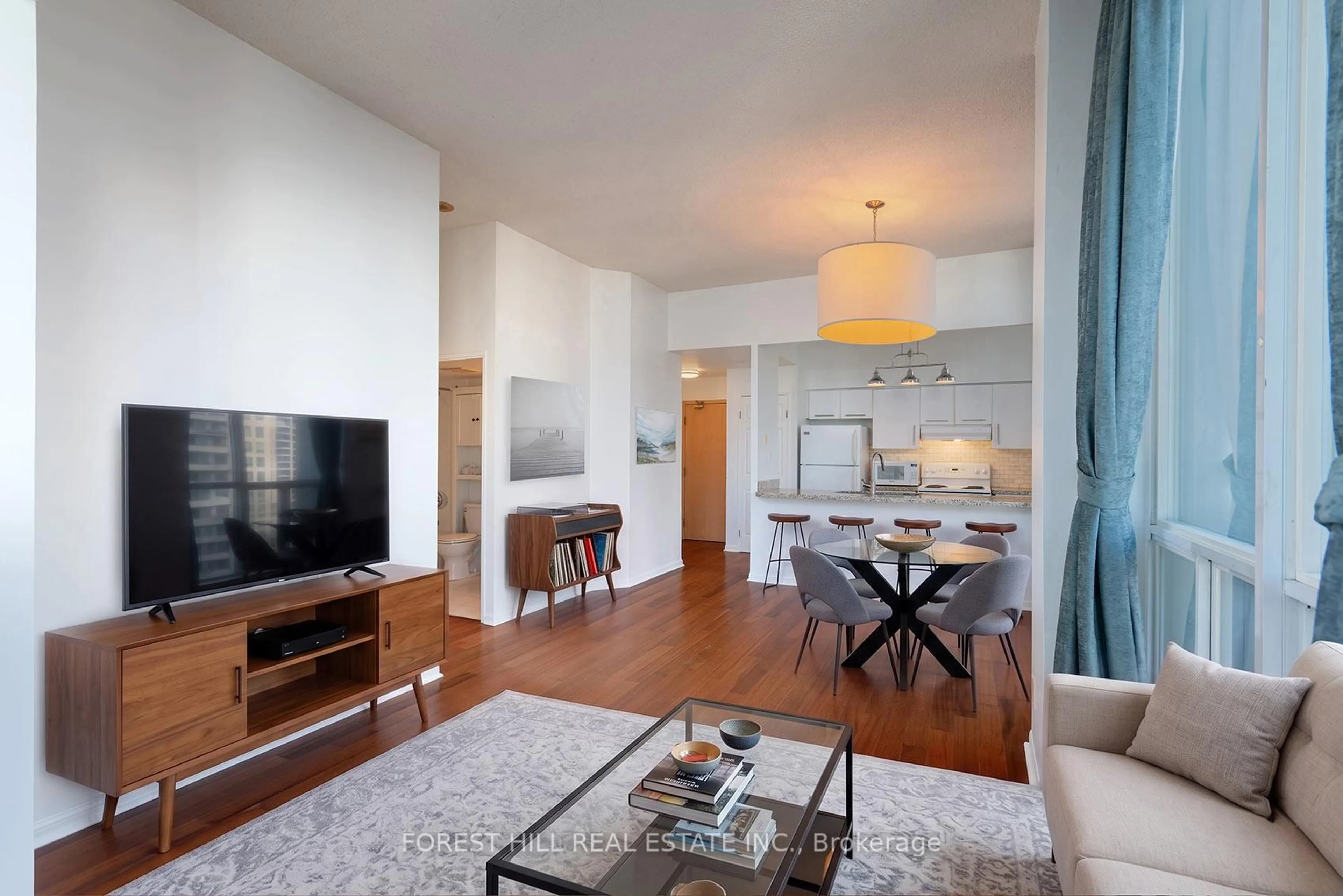 Living room with furniture, wood/laminate floor for 24 Wellesley St #2405, Toronto Ontario M4Y 2X6