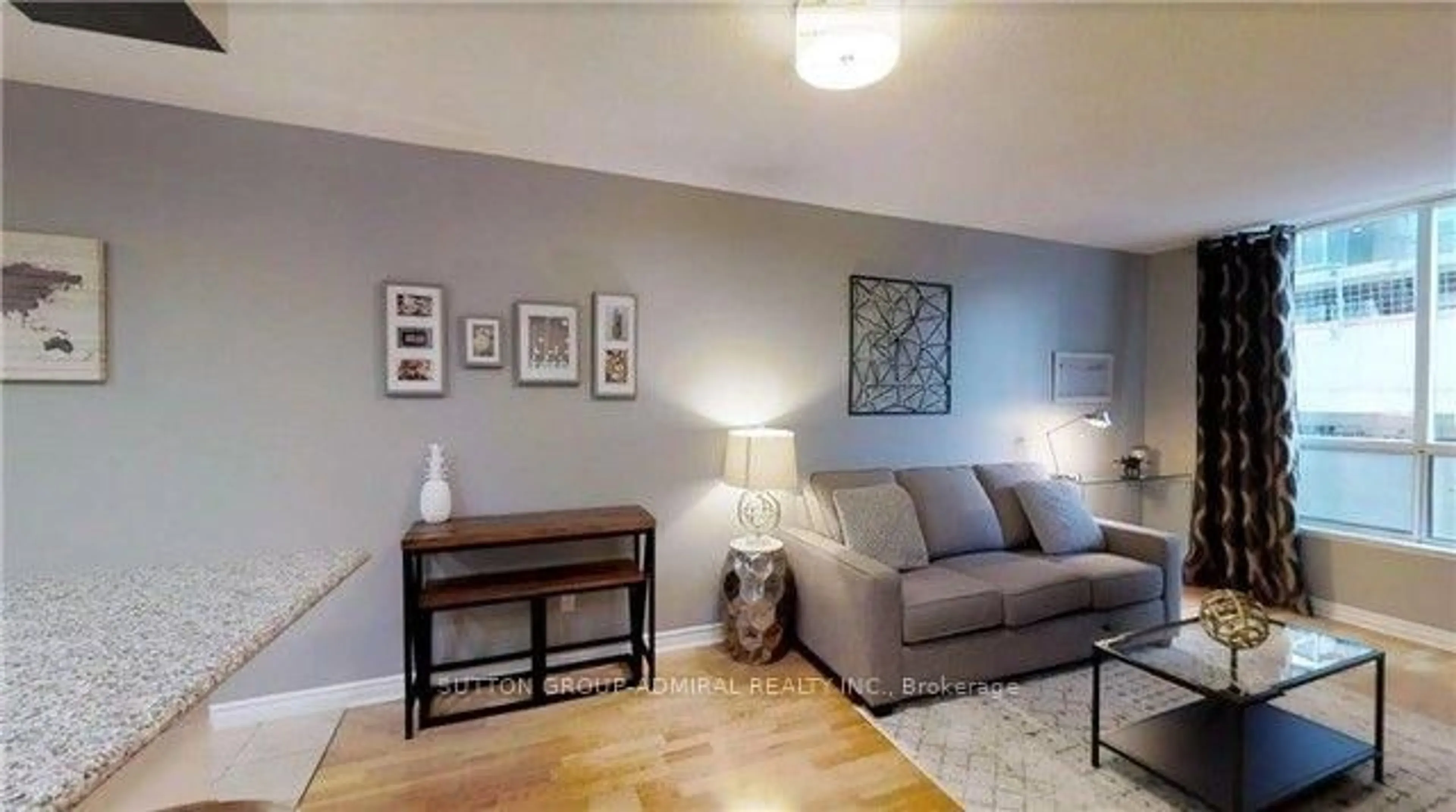 Living room with furniture, wood/laminate floor for 168 Simcoe St #722, Toronto Ontario M5H 4C9