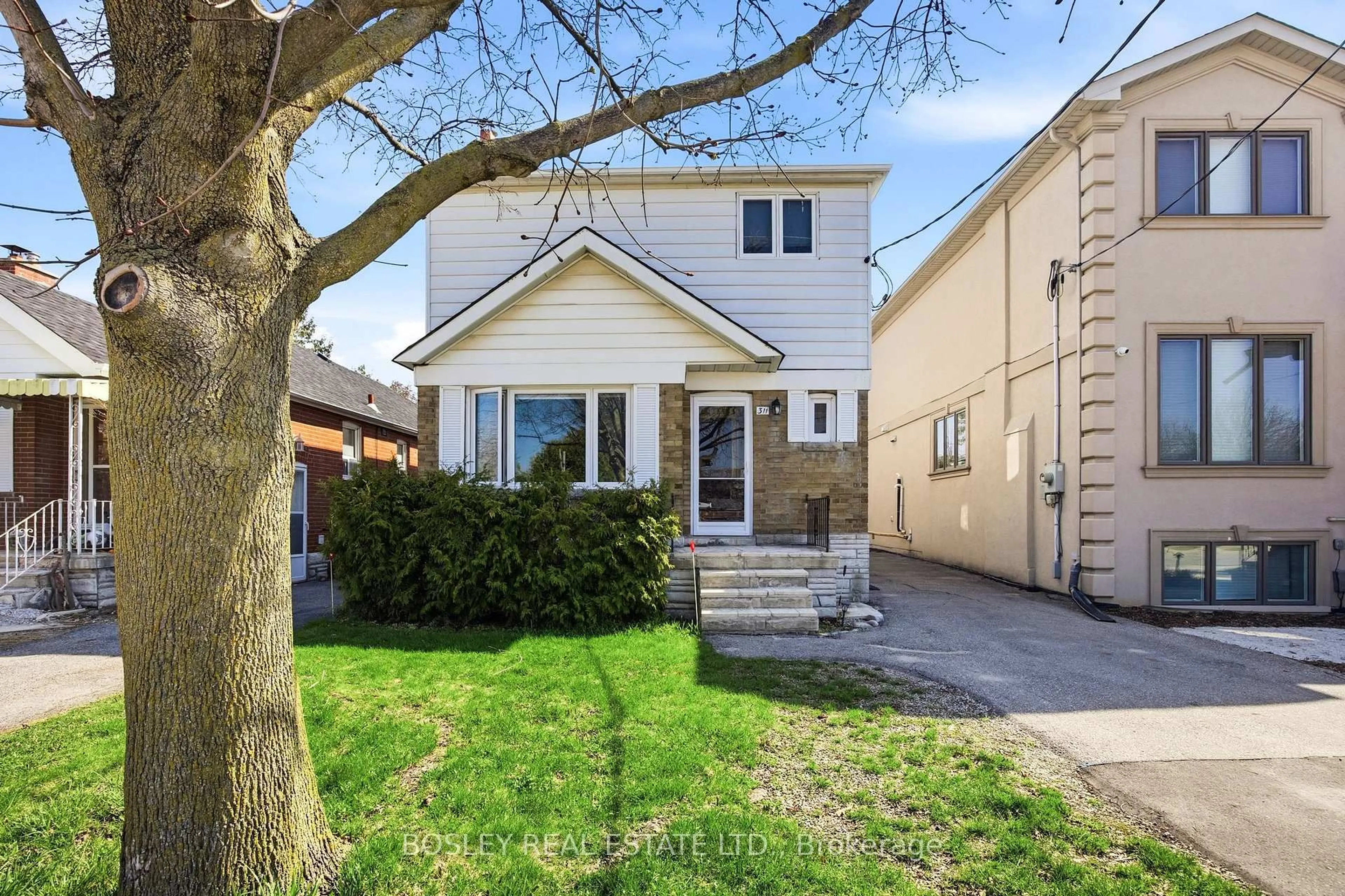Home with vinyl exterior material, street for 311 Laird Dr, Toronto Ontario M4G 3X7