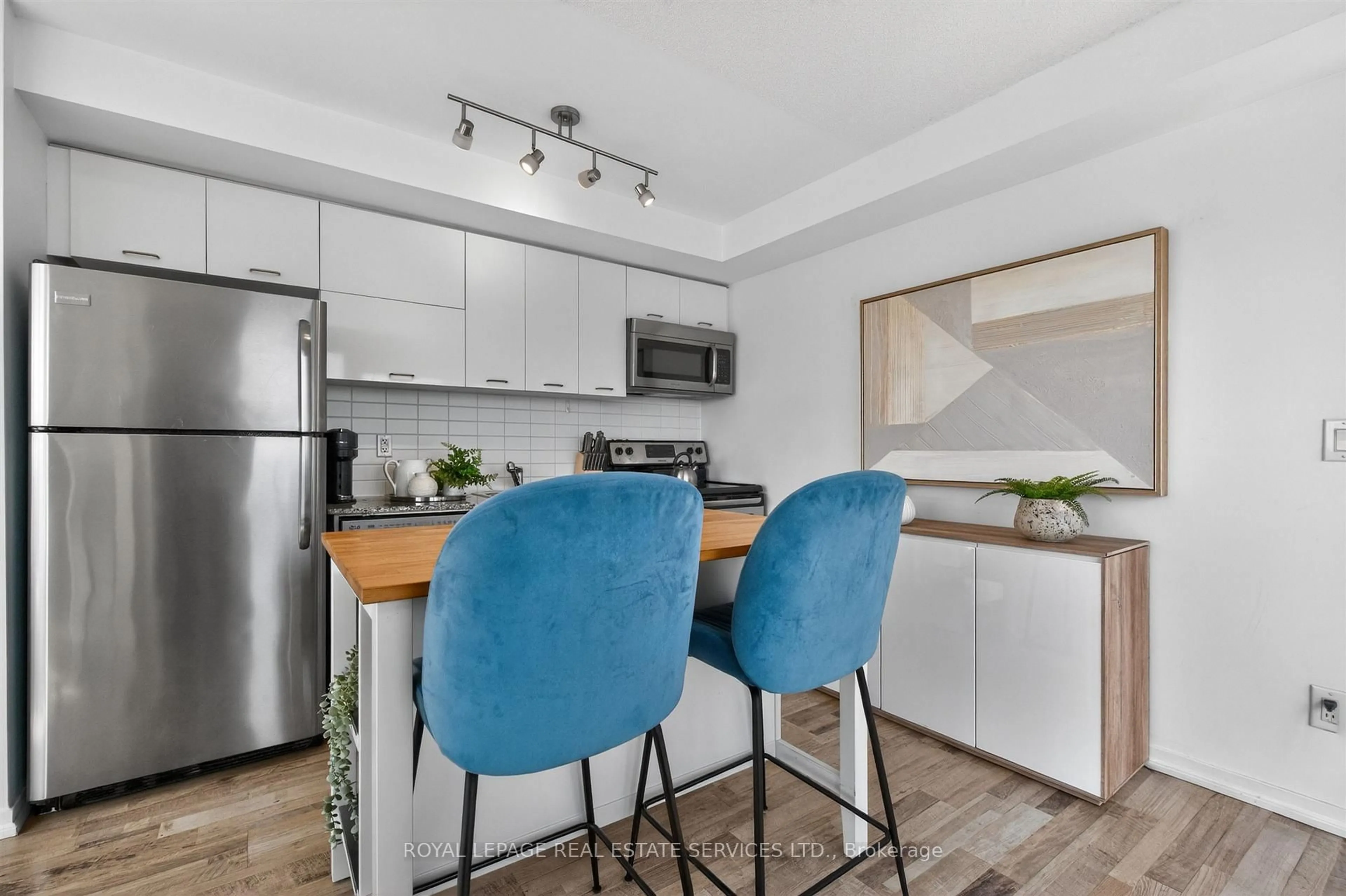 Open concept kitchen, wood/laminate floor for 38 Joe Shuster Way #1318, Toronto Ontario M6K 0A5