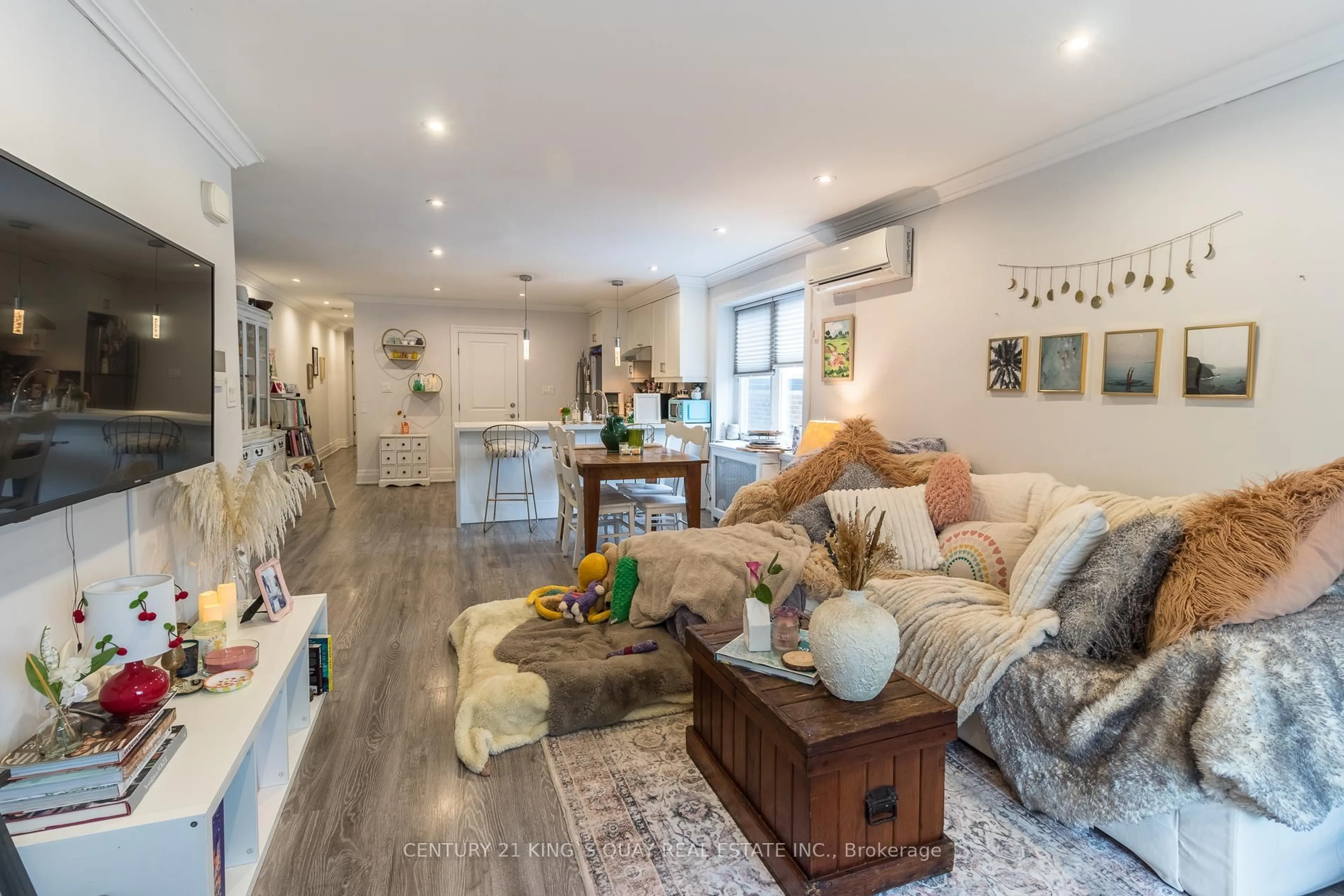 Living room with furniture, wood/laminate floor for 301 Cleveland St, Toronto Ontario M4S 2W7