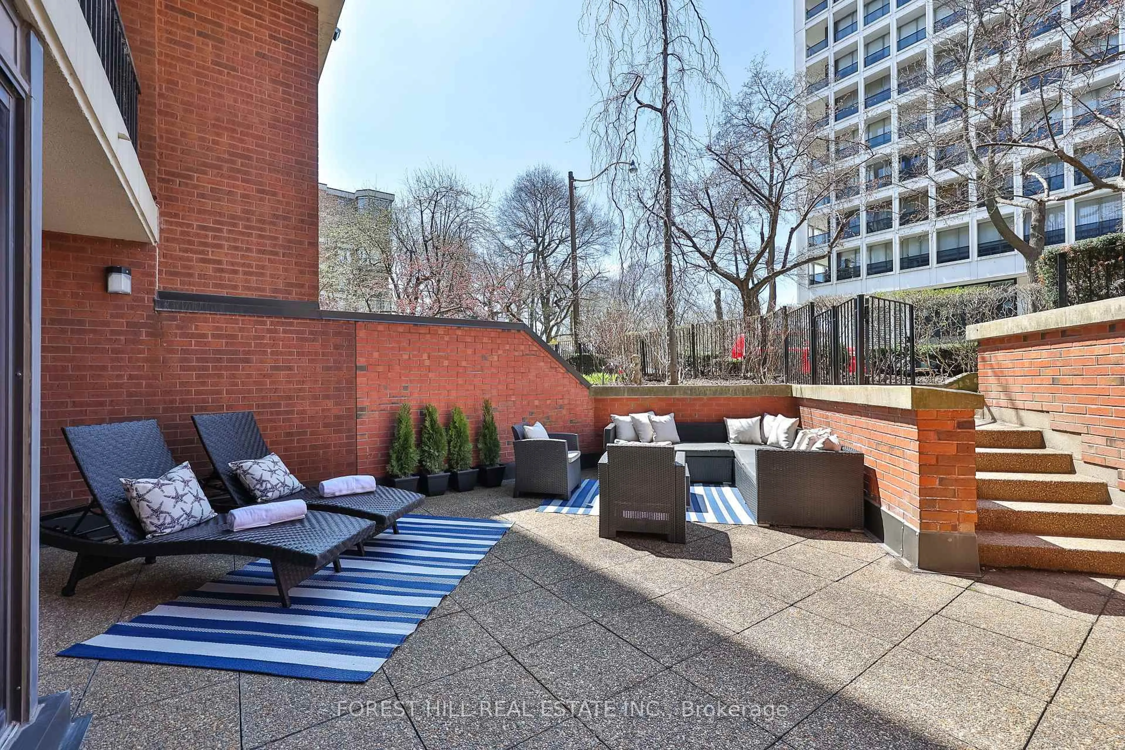 Patio, city buildings view from balcony for 349 St Clair Ave #115, Toronto Ontario M5P 1N3