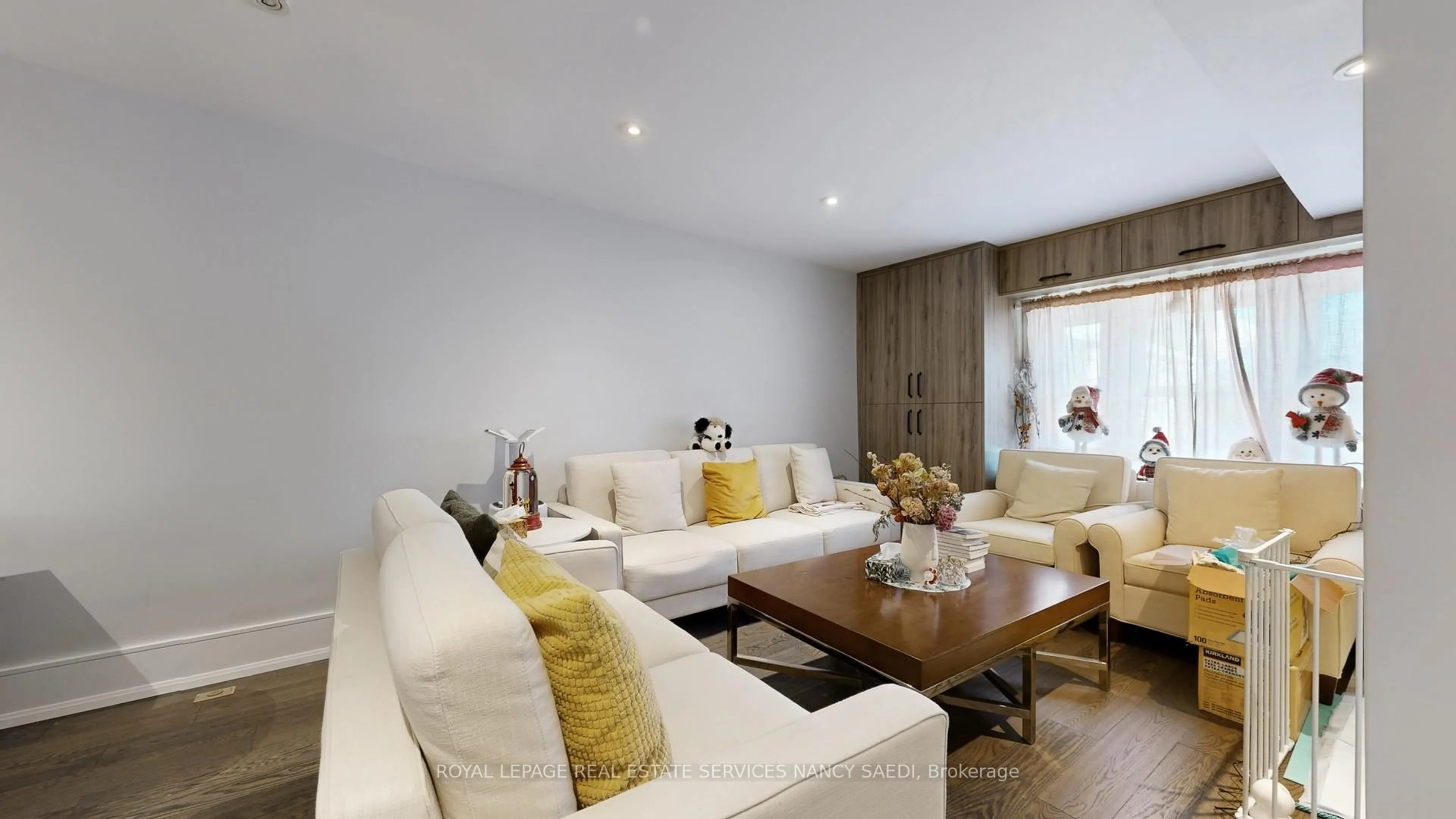 Living room with furniture, wood/laminate floor for 72 Mann Ave, Toronto Ontario M4S 2Y3