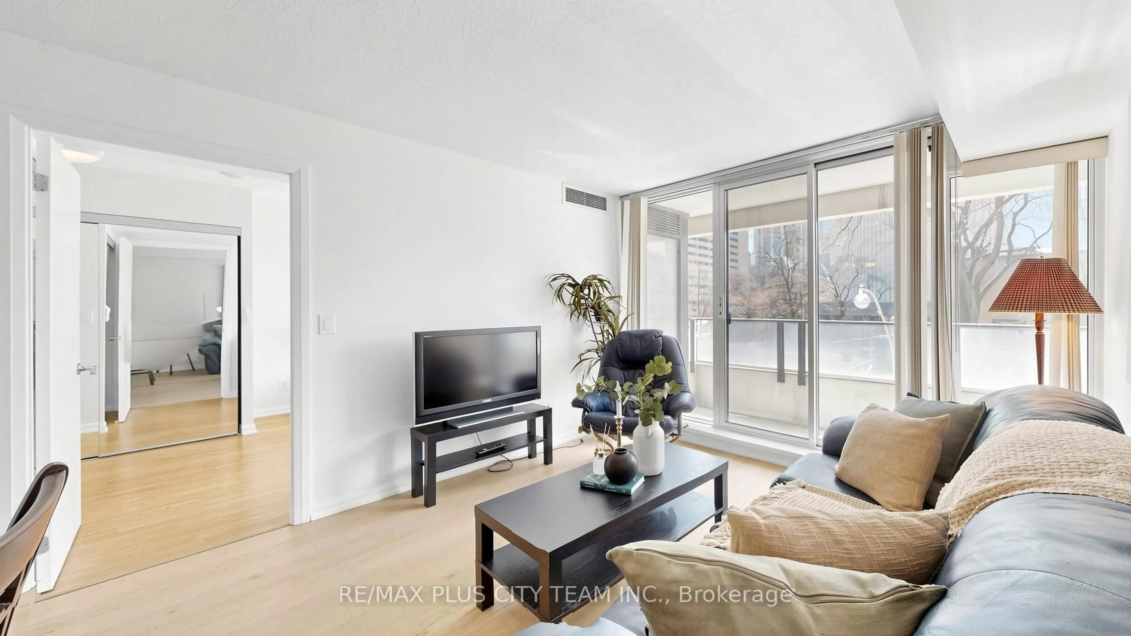 Living room with furniture, wood/laminate floor for 111 Elizabeth St #308, Toronto Ontario M5G 1P7