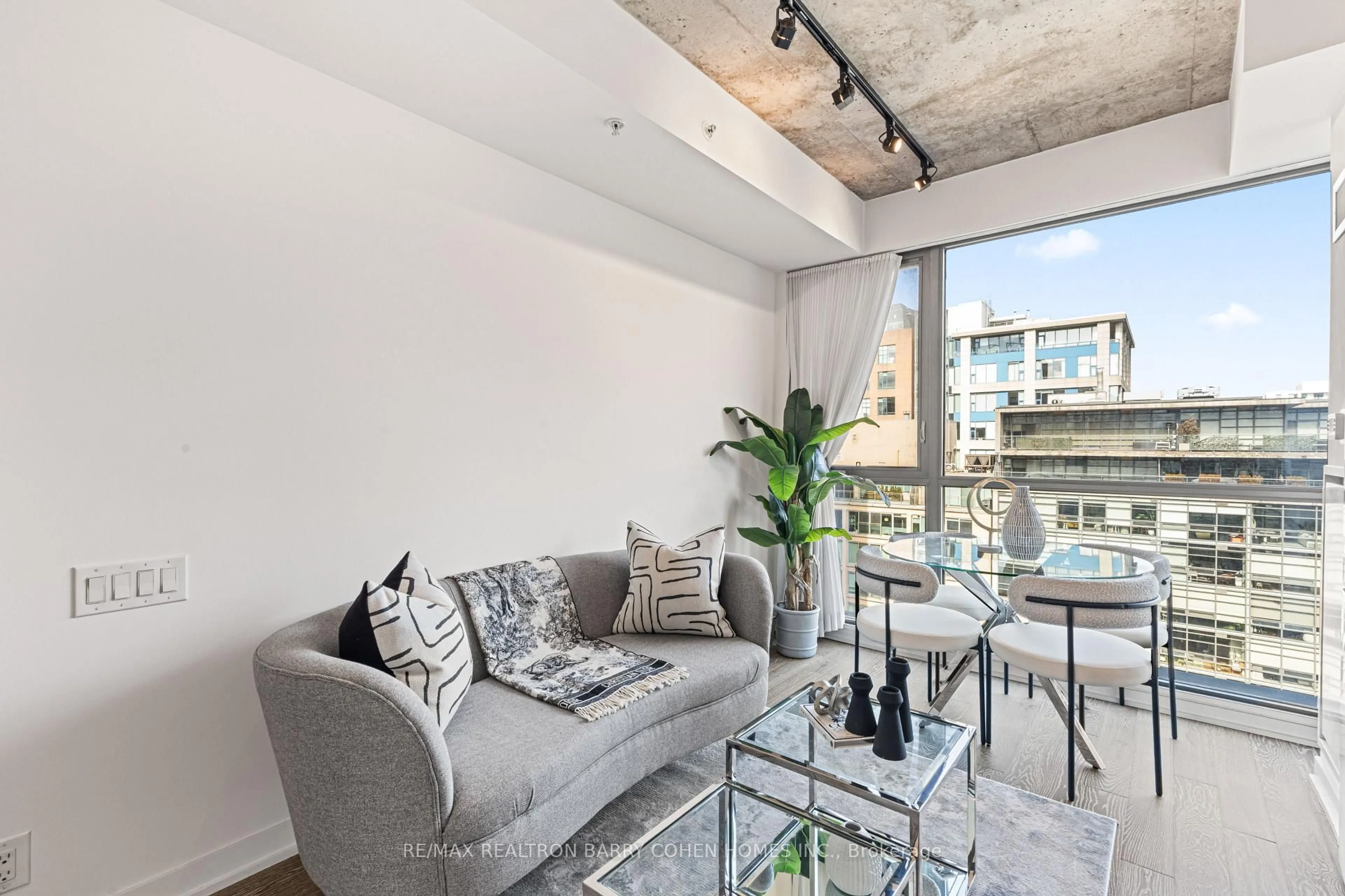 Living room with furniture, cement floor for 39 Brant St #904, Toronto Ontario M5V 0M8