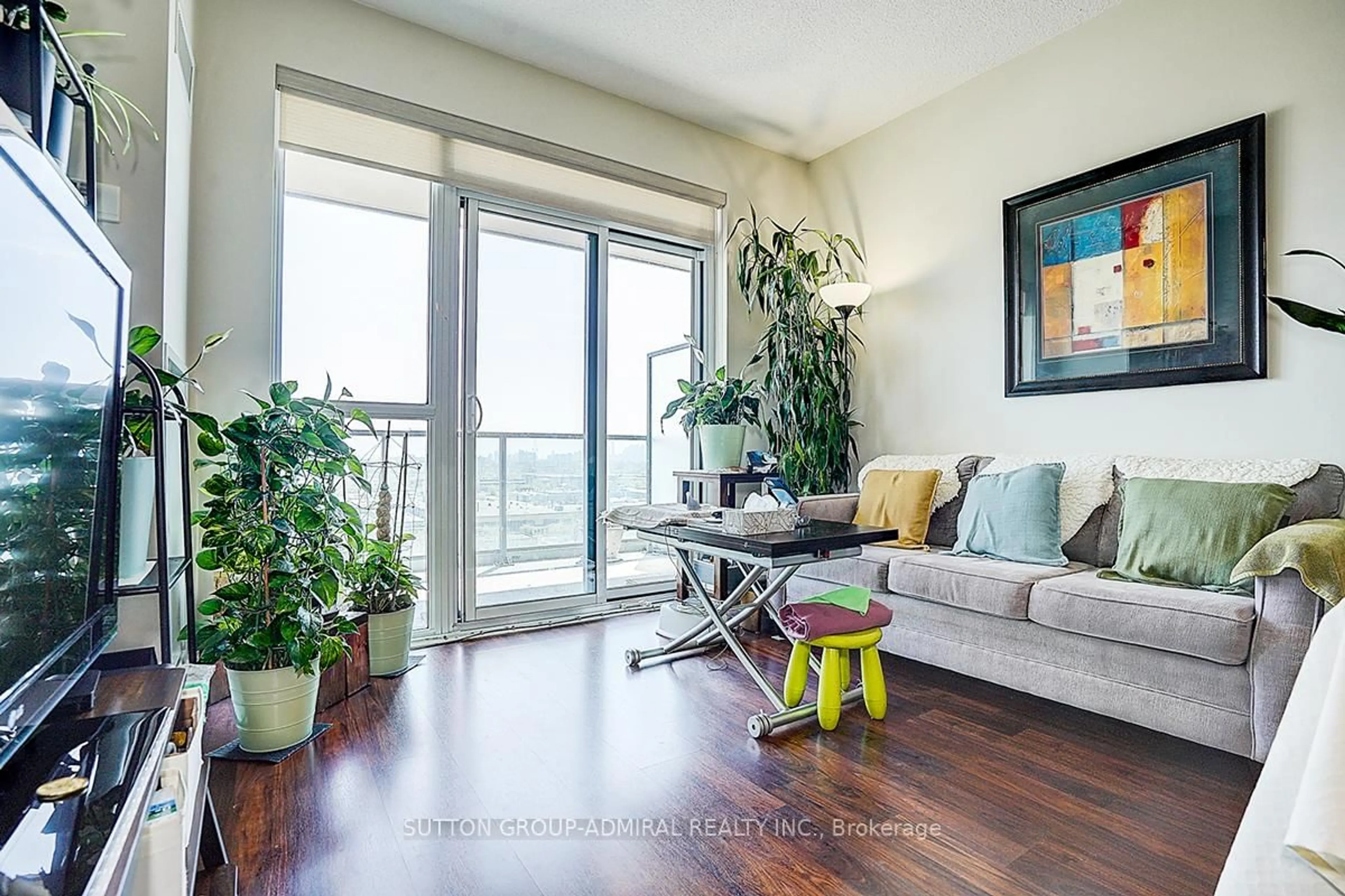 Living room with furniture, wood/laminate floor for 35 Brian Peck Cres #1413, Toronto Ontario M4G 0A5