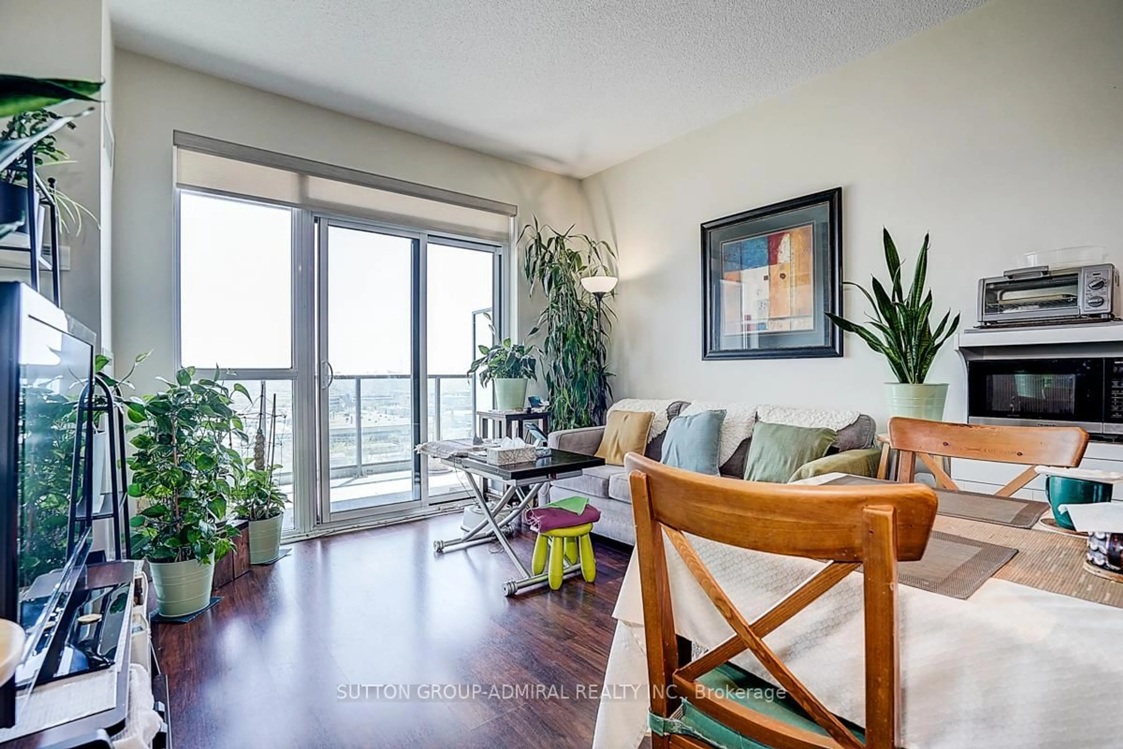 Living room with furniture, wood/laminate floor for 35 Brian Peck Cres #1413, Toronto Ontario M4G 0A5