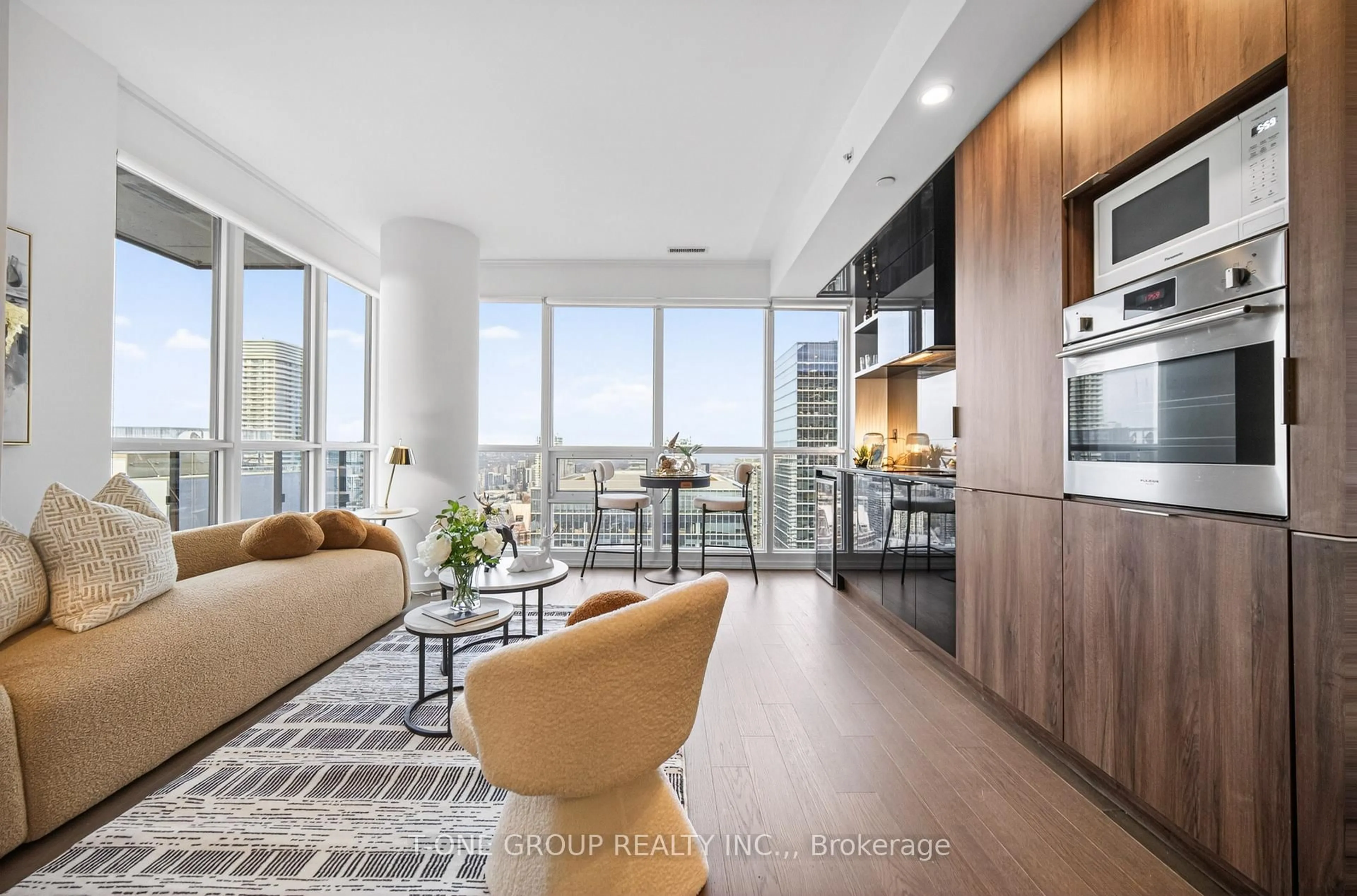 Living room with furniture, wood/laminate floor for 70 Temperance St #4903, Toronto Ontario M5H 4E8