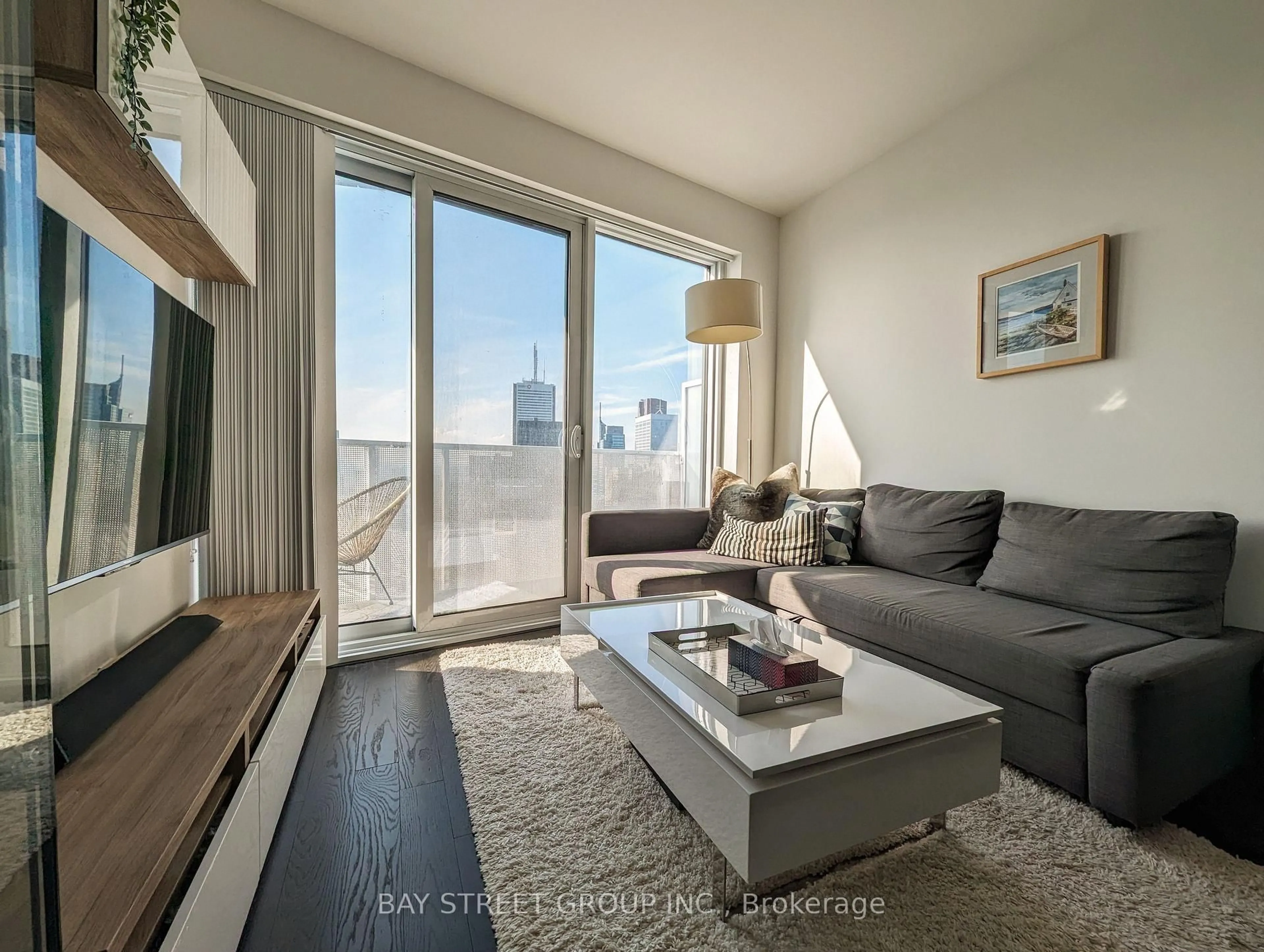 Living room with furniture, wood/laminate floor for 100 Harbour St #6103, Toronto Ontario M5J 0B5
