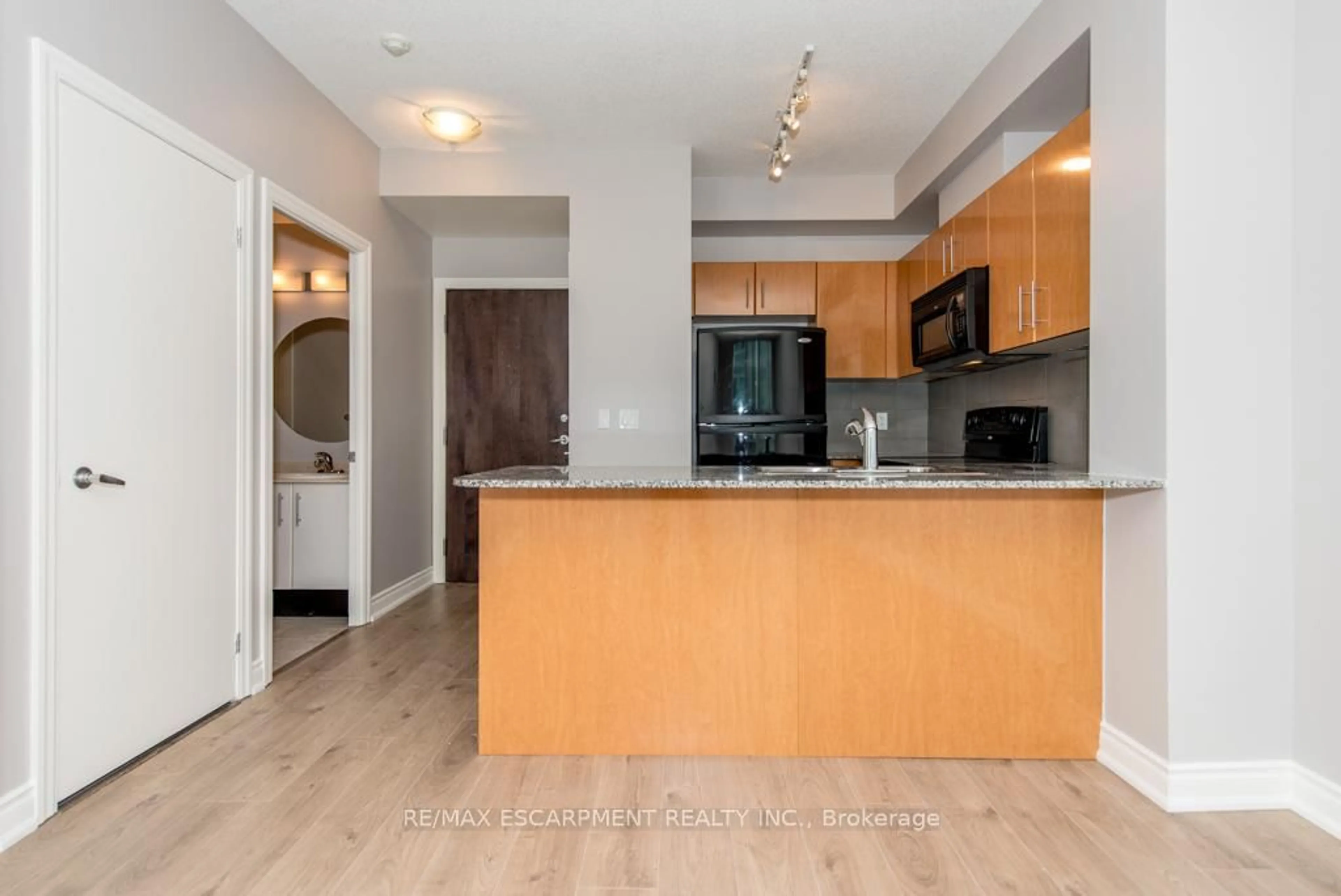 Open concept kitchen, wood/laminate floor for 16 Yonge St #2903, Toronto Ontario M5E 2A1