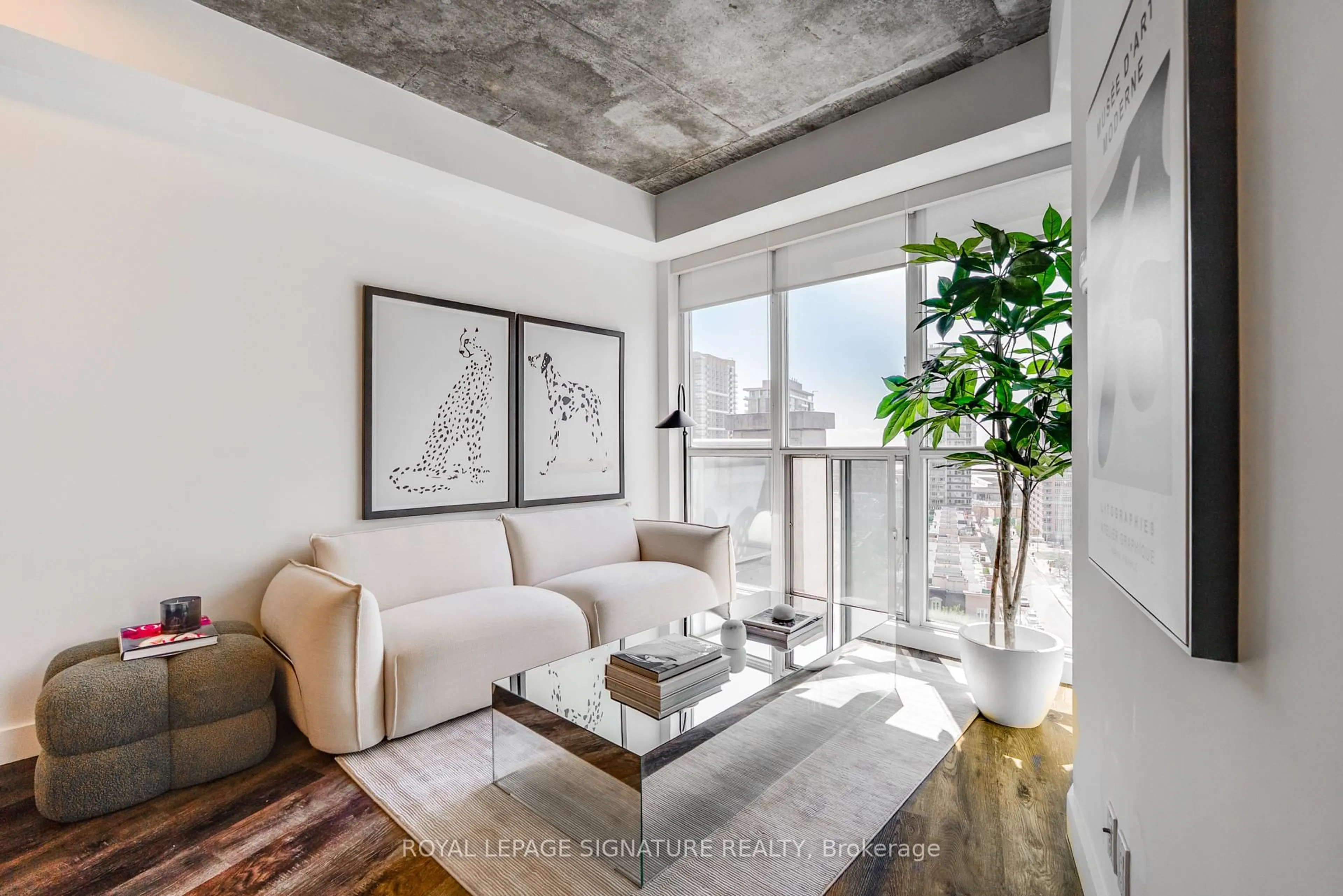 Living room with furniture, cement floor for 1 Shaw St #1421, Toronto Ontario M6K 0A1