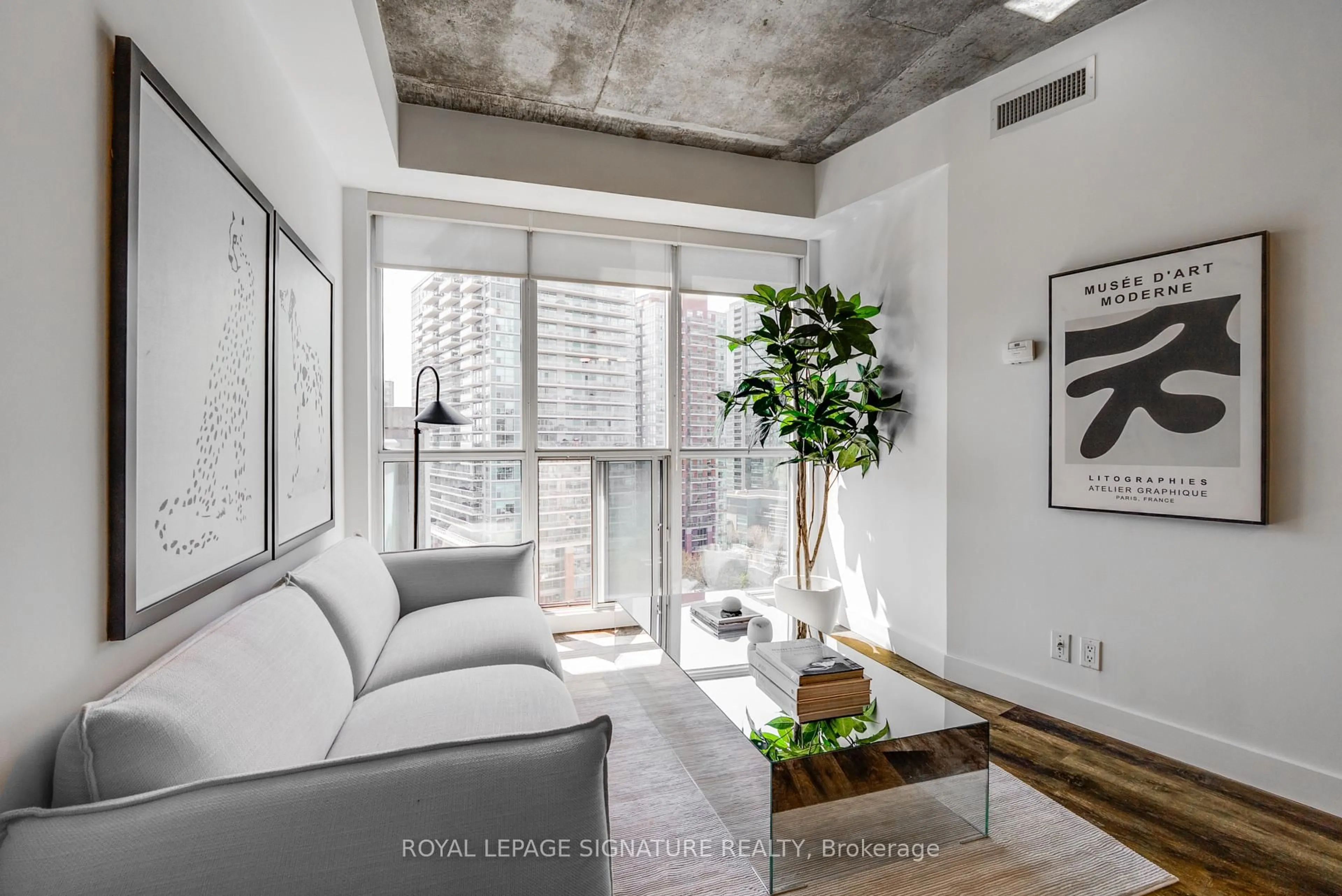 Living room with furniture, cement floor for 1 Shaw St #1421, Toronto Ontario M6K 0A1