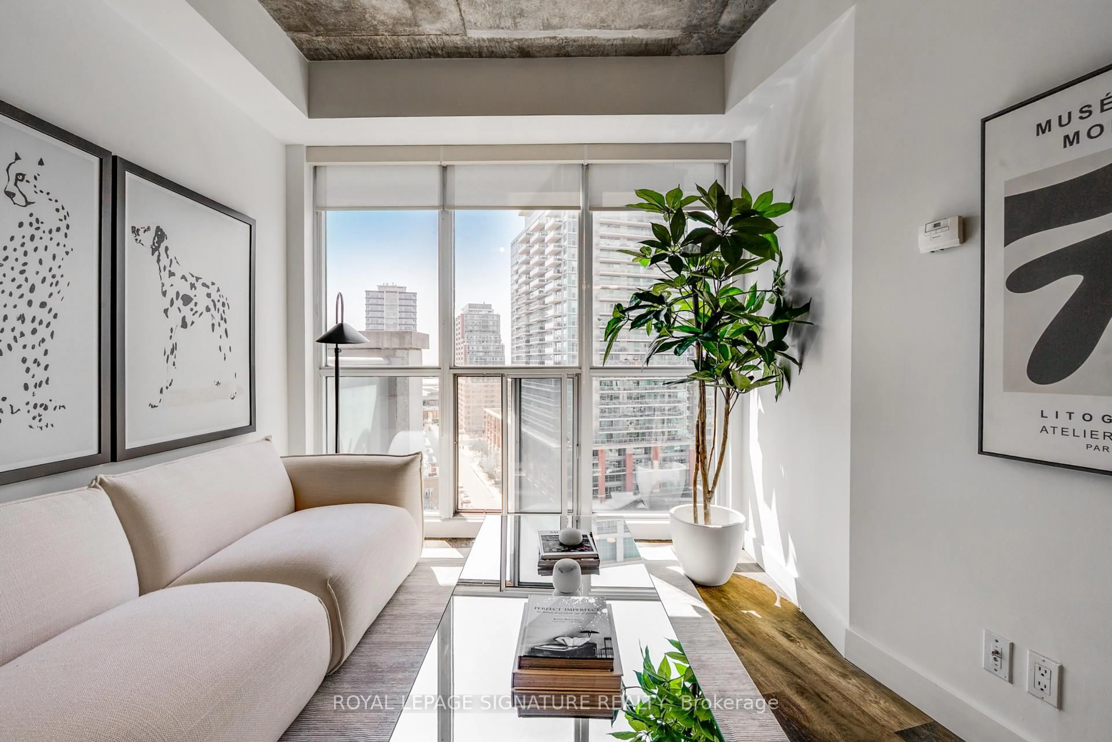 Living room with furniture, cement floor for 1 Shaw St #1421, Toronto Ontario M6K 0A1