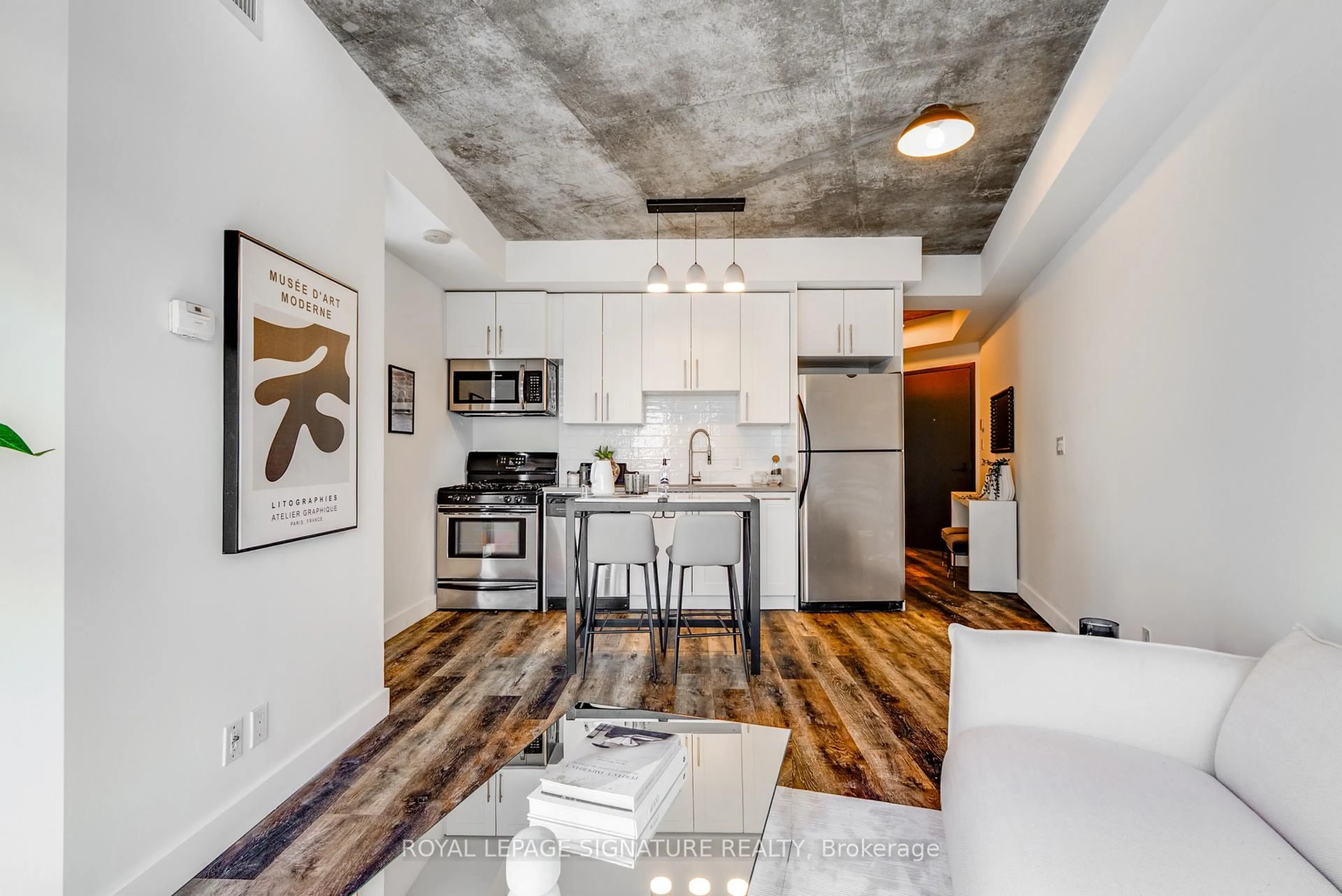 Open concept kitchen, cement floor for 1 Shaw St #1421, Toronto Ontario M6K 0A1