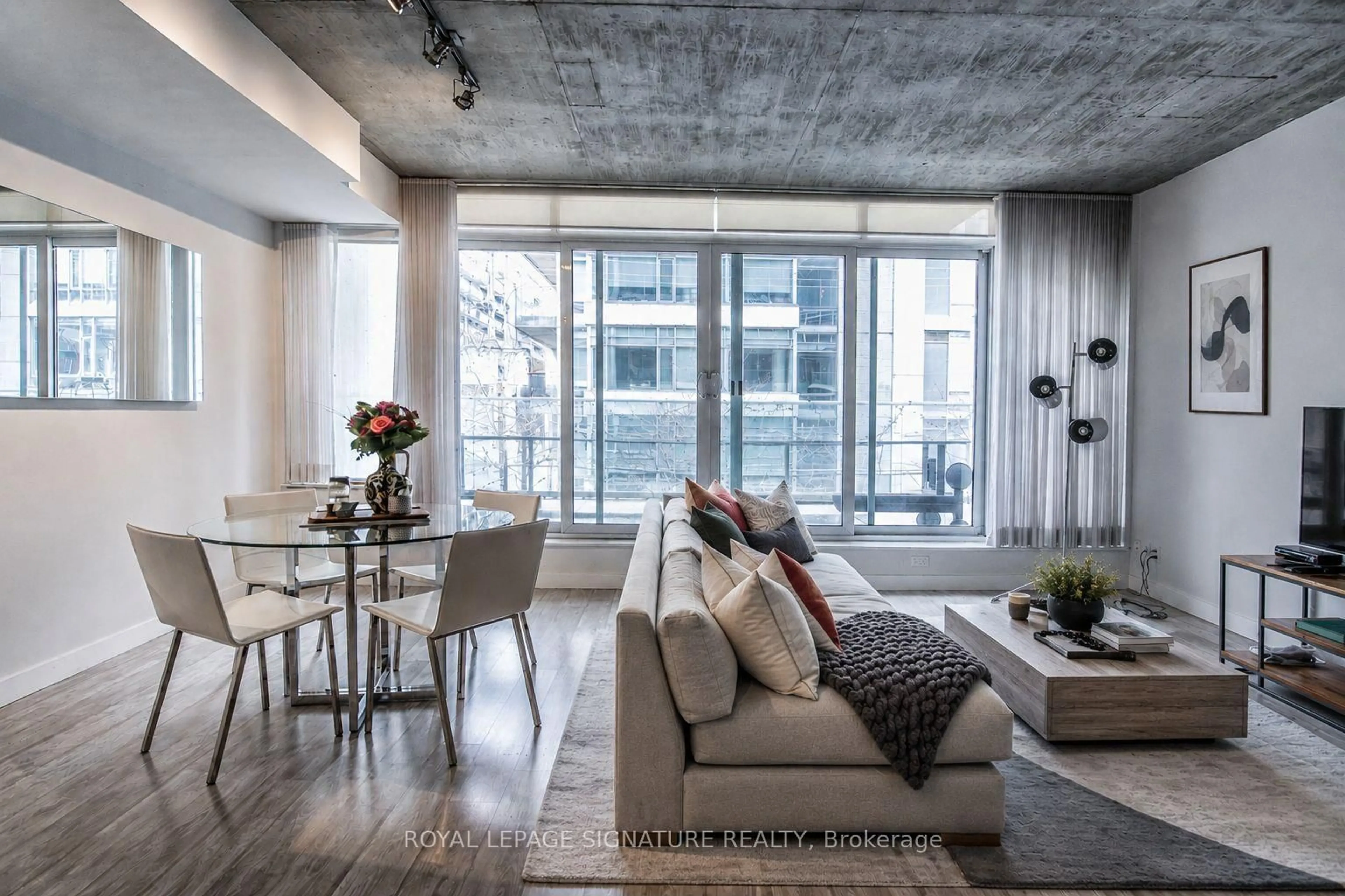 Living room with furniture, cement floor for 75 Portland St #306, Toronto Ontario M5V 2M9
