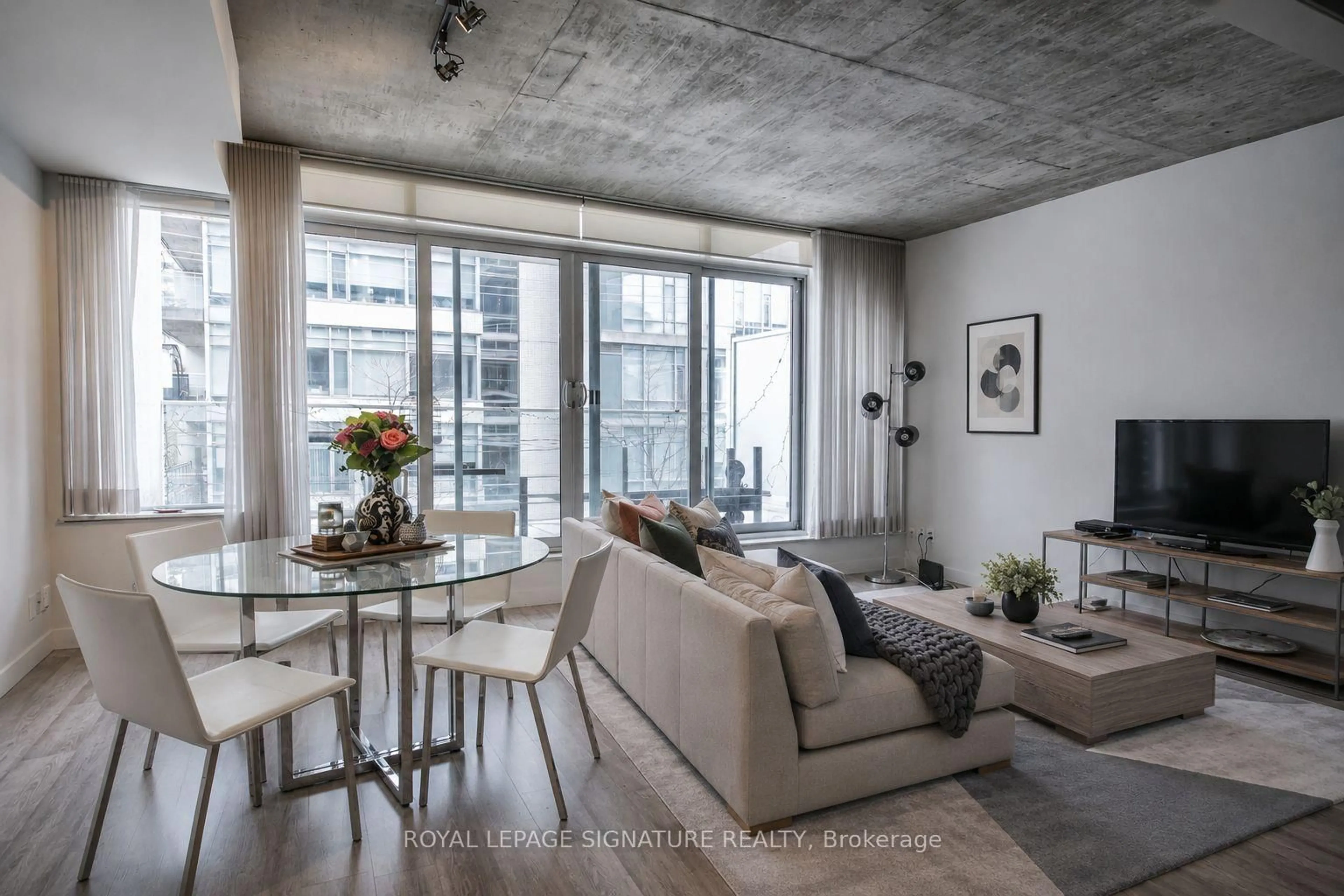 Living room with furniture, cement floor for 75 Portland St #306, Toronto Ontario M5V 2M9