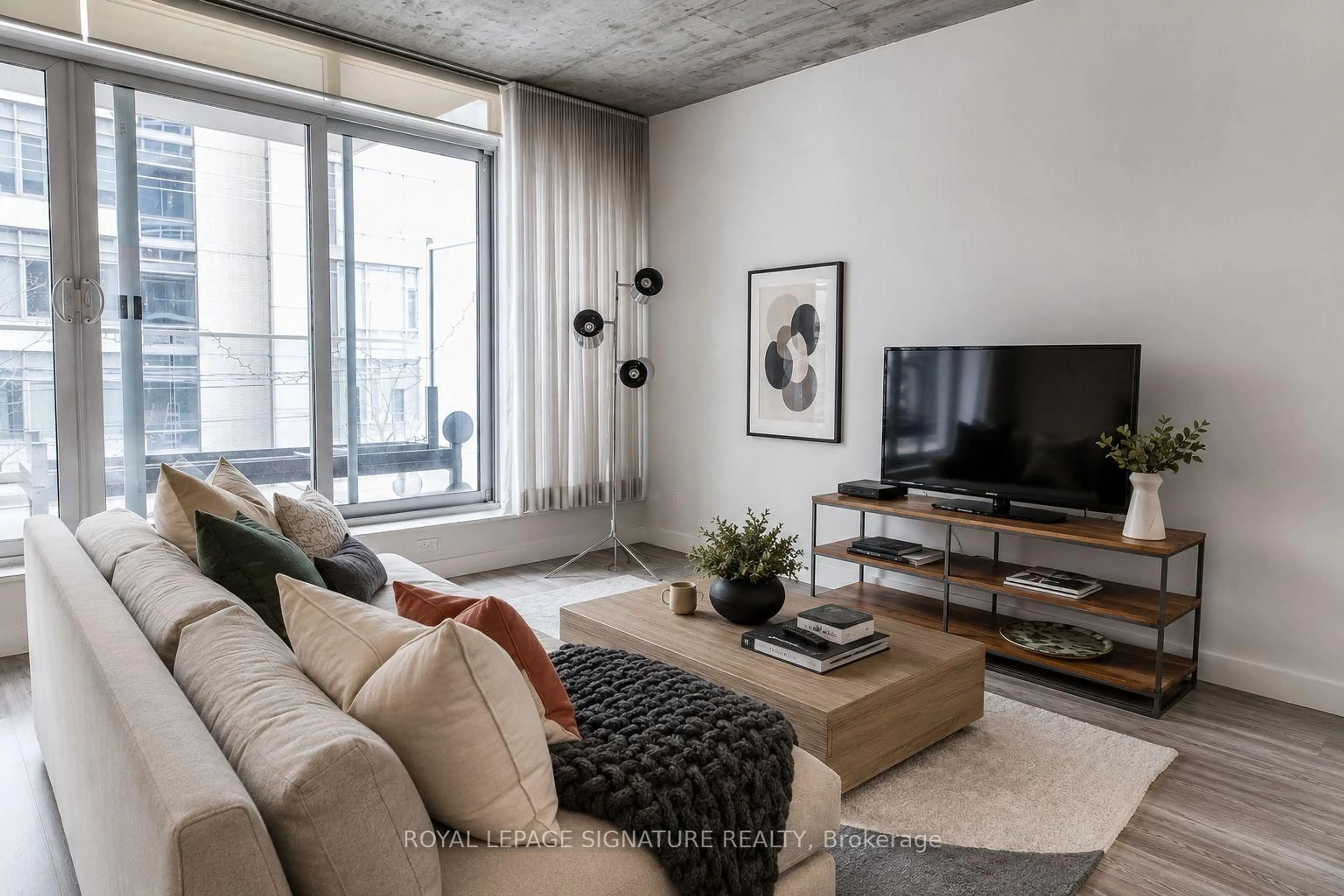 Living room with furniture, cement floor for 75 Portland St #306, Toronto Ontario M5V 2M9
