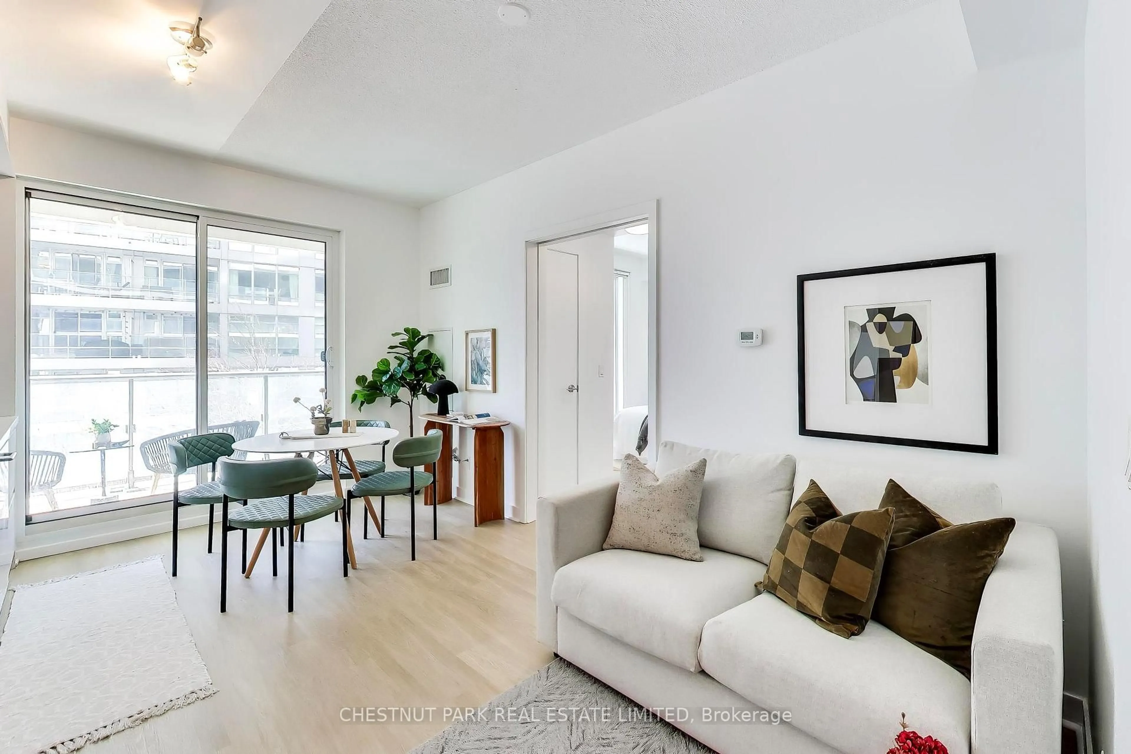 Living room with furniture, wood/laminate floor for 2221 Yonge St #406, Toronto Ontario M4S 0B8