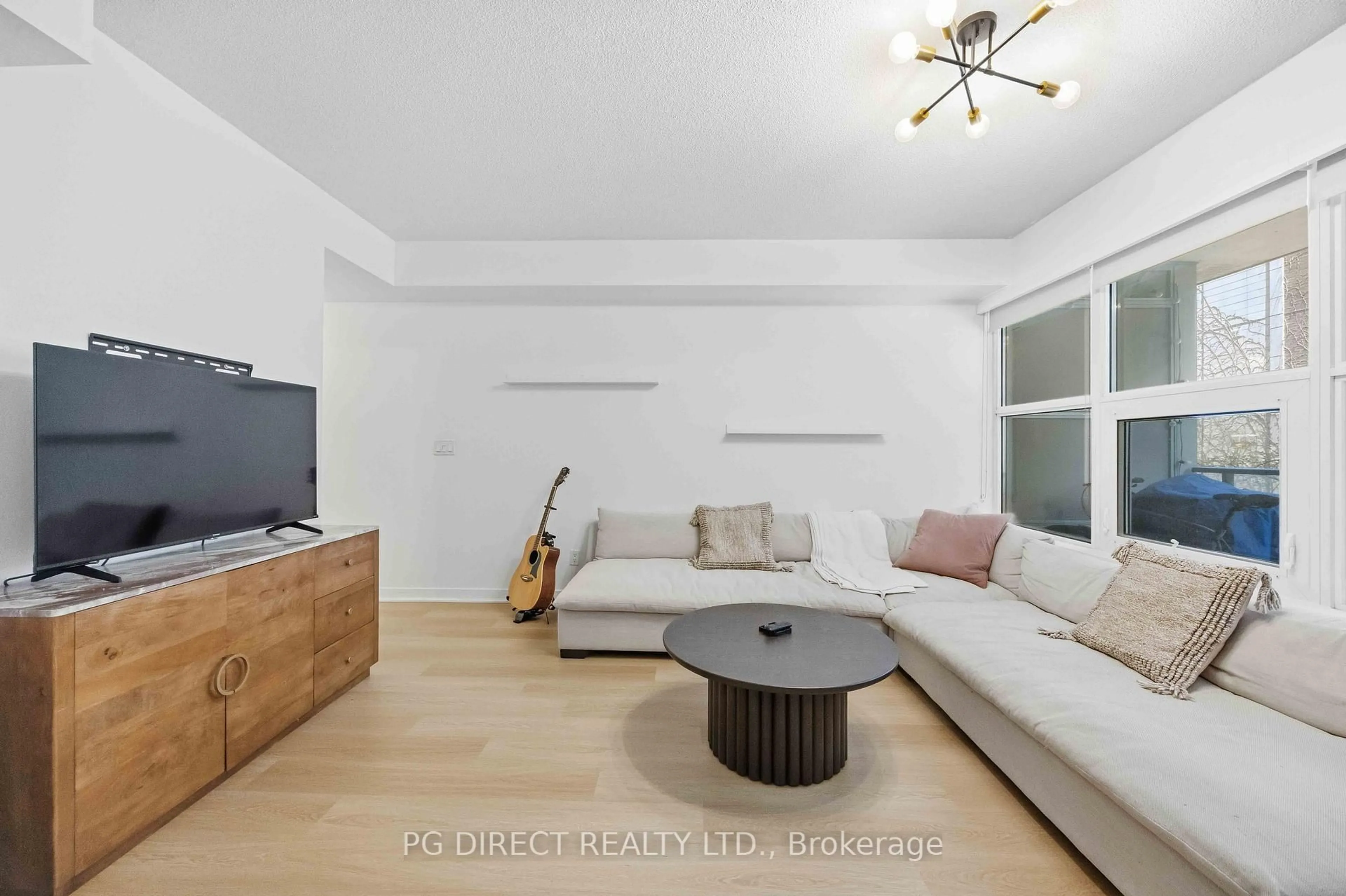 Living room with furniture, wood/laminate floor for 59 East Liberty St #213, Toronto Ontario M6K 3R1
