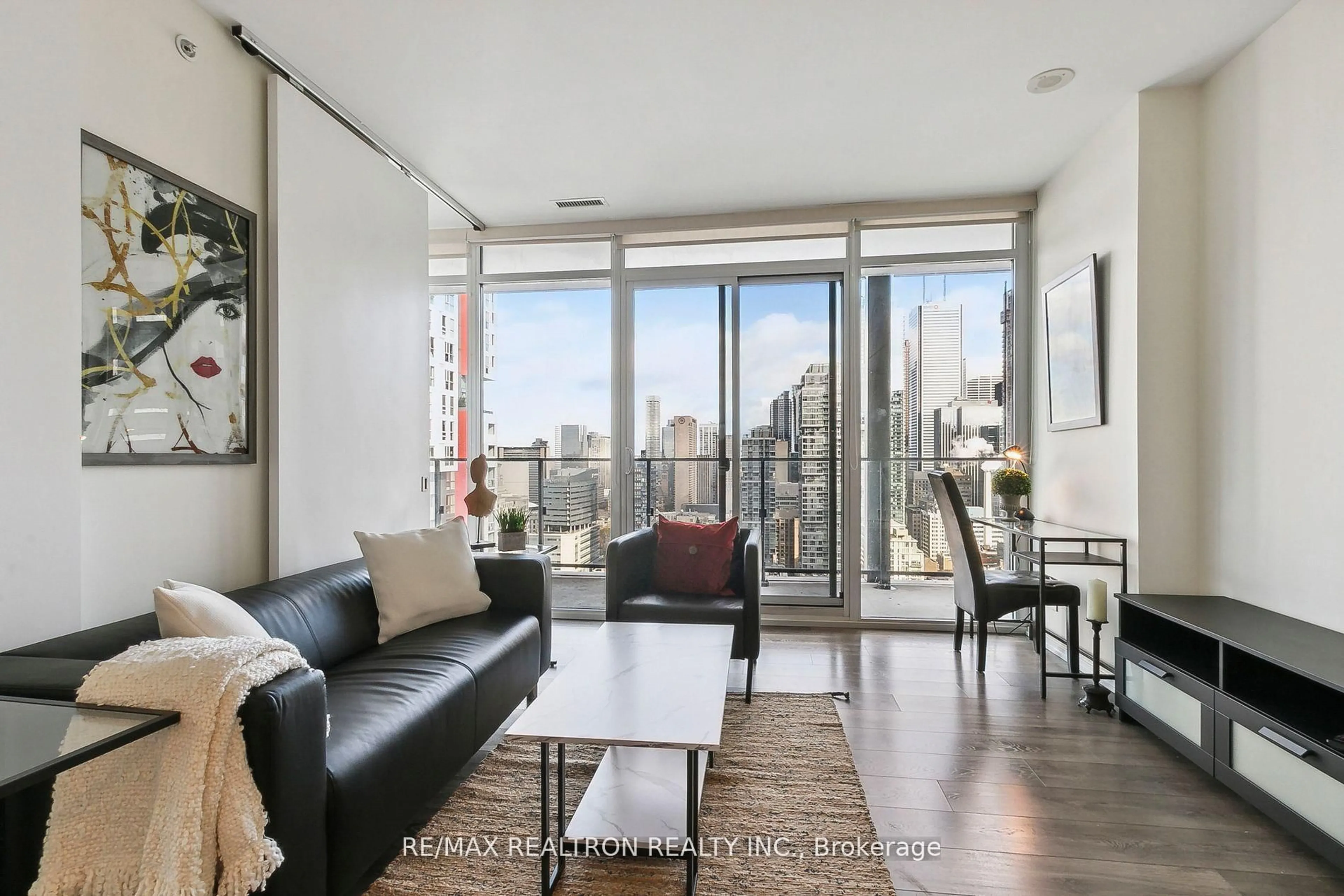 Living room with furniture, wood/laminate floor for 125 Peter St #2708, Toronto Ontario M5V 2E9