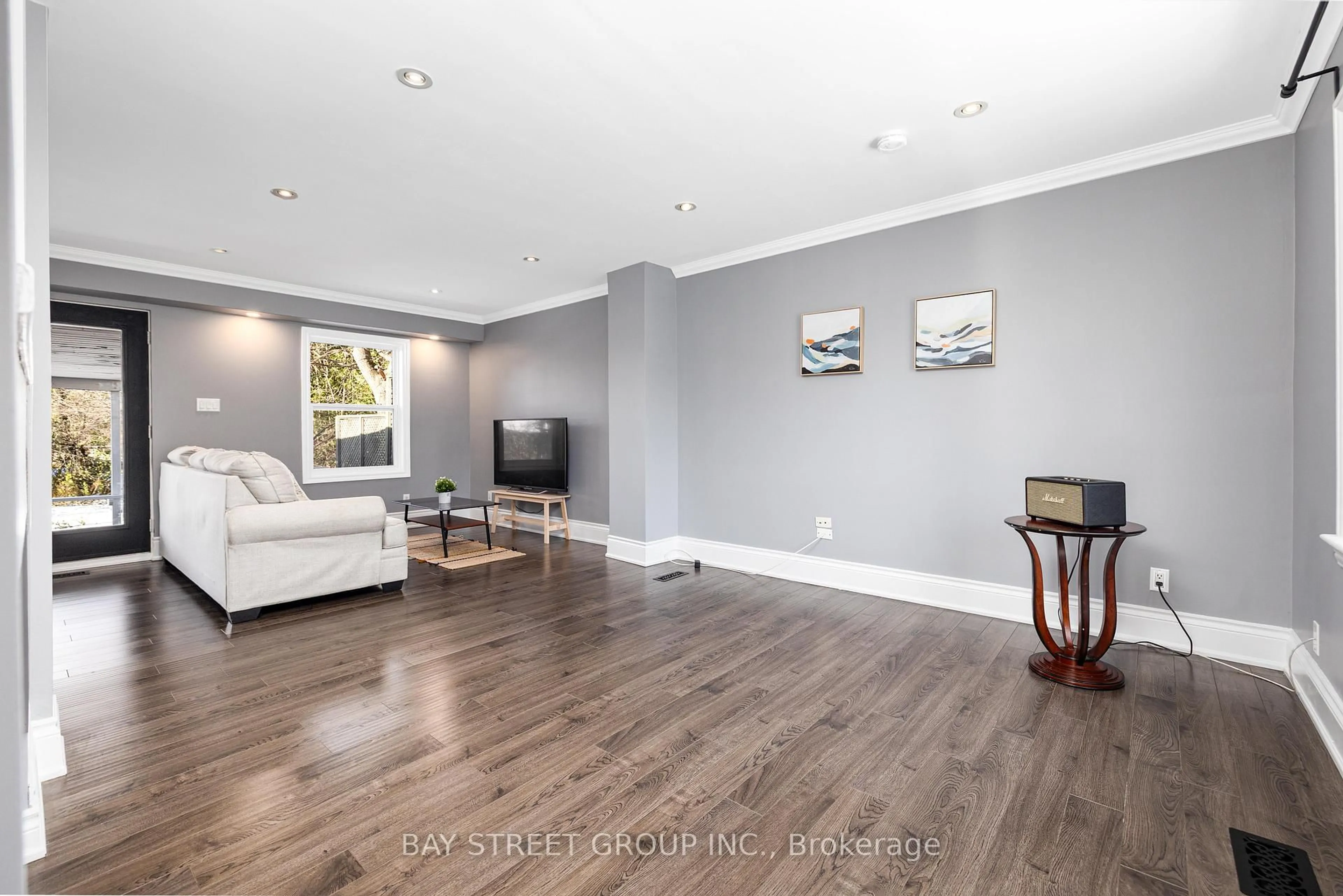 Living room with furniture, wood/laminate floor for 112 Bevdale Rd, Toronto Ontario M2R 1L7