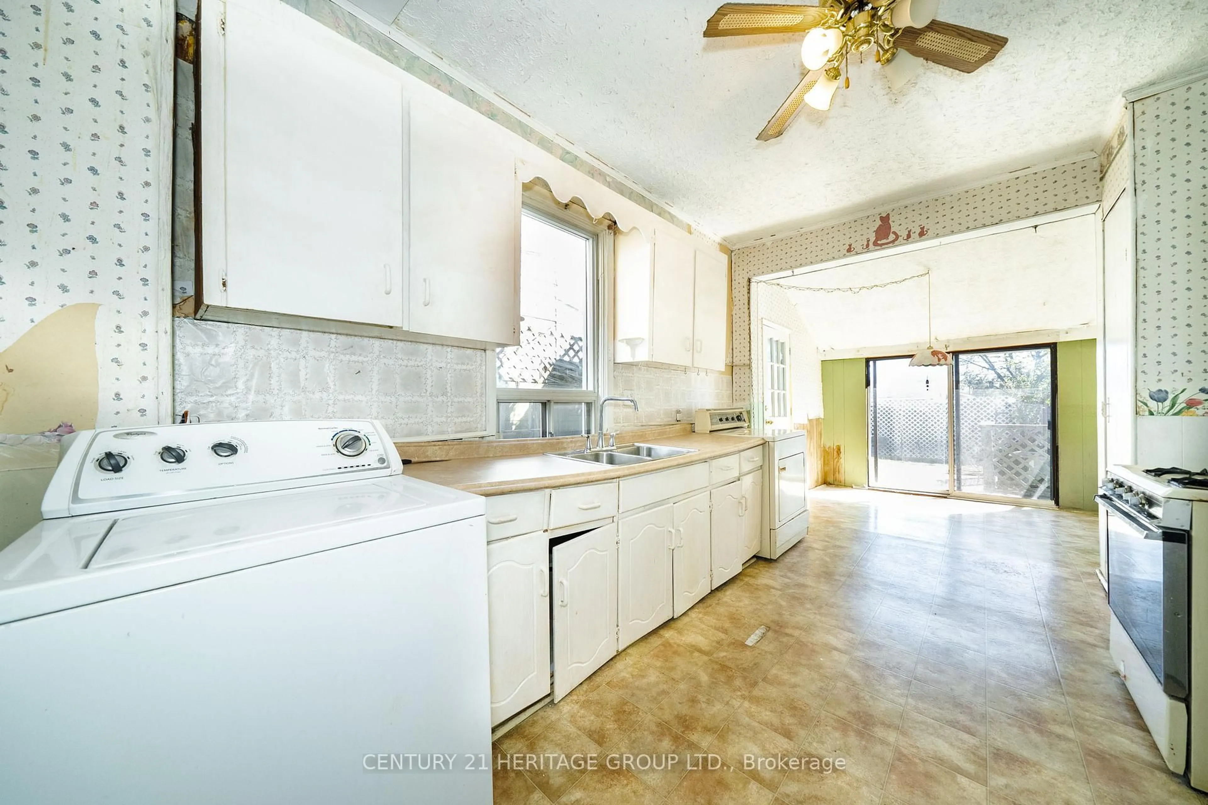 Kitchen with laundary machines, ceramic/tile floor for 403 Brock Ave, Toronto Ontario M6H 3N6