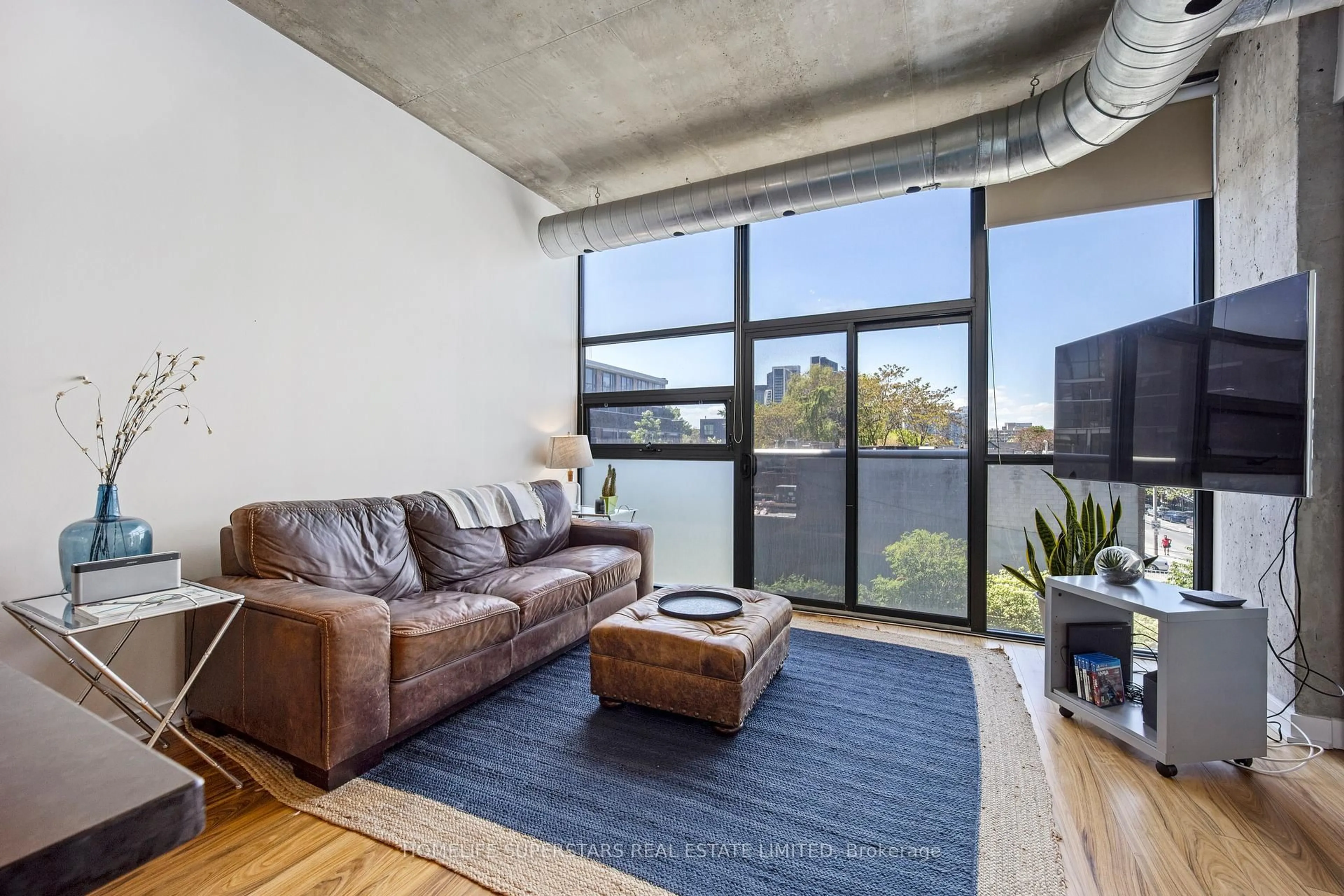 Living room with furniture, cement floor for 60 Bathurst St #303, Toronto Ontario M5V 2P4
