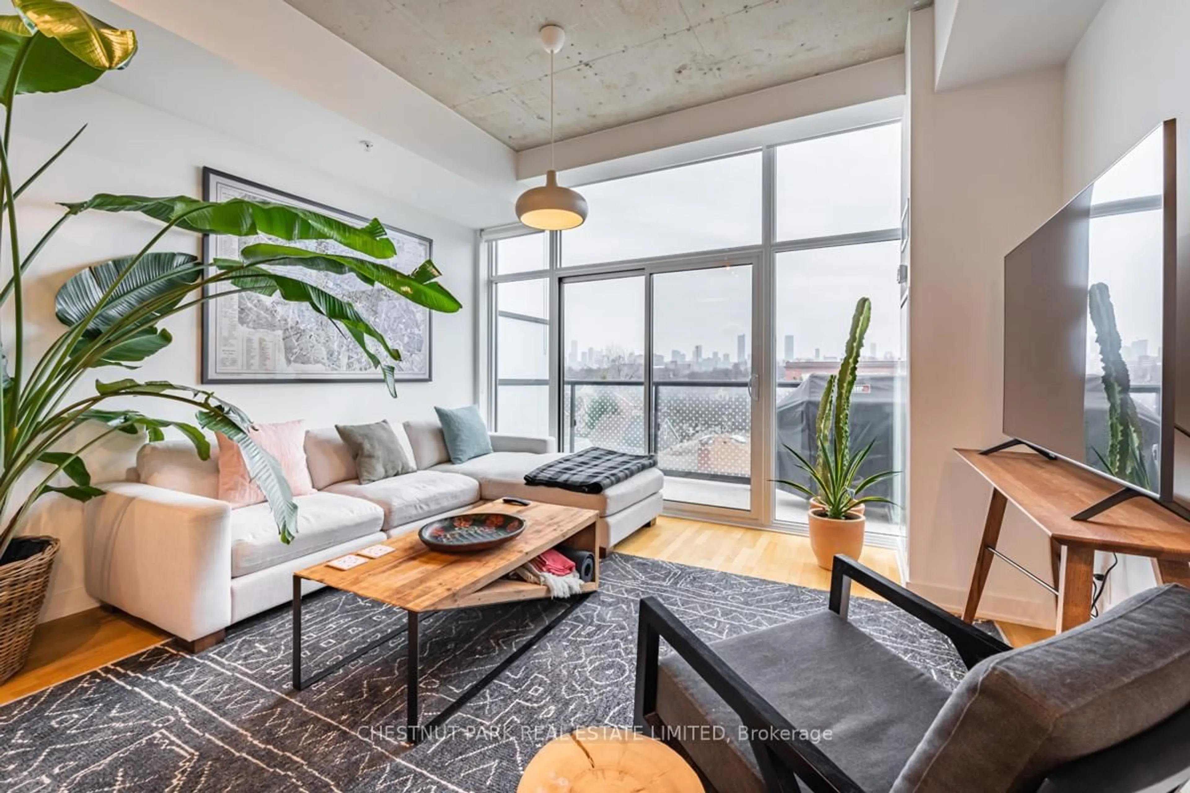 Living room with furniture, cement floor for 109 Ossington Ave #509, Toronto Ontario M6J 2Z2
