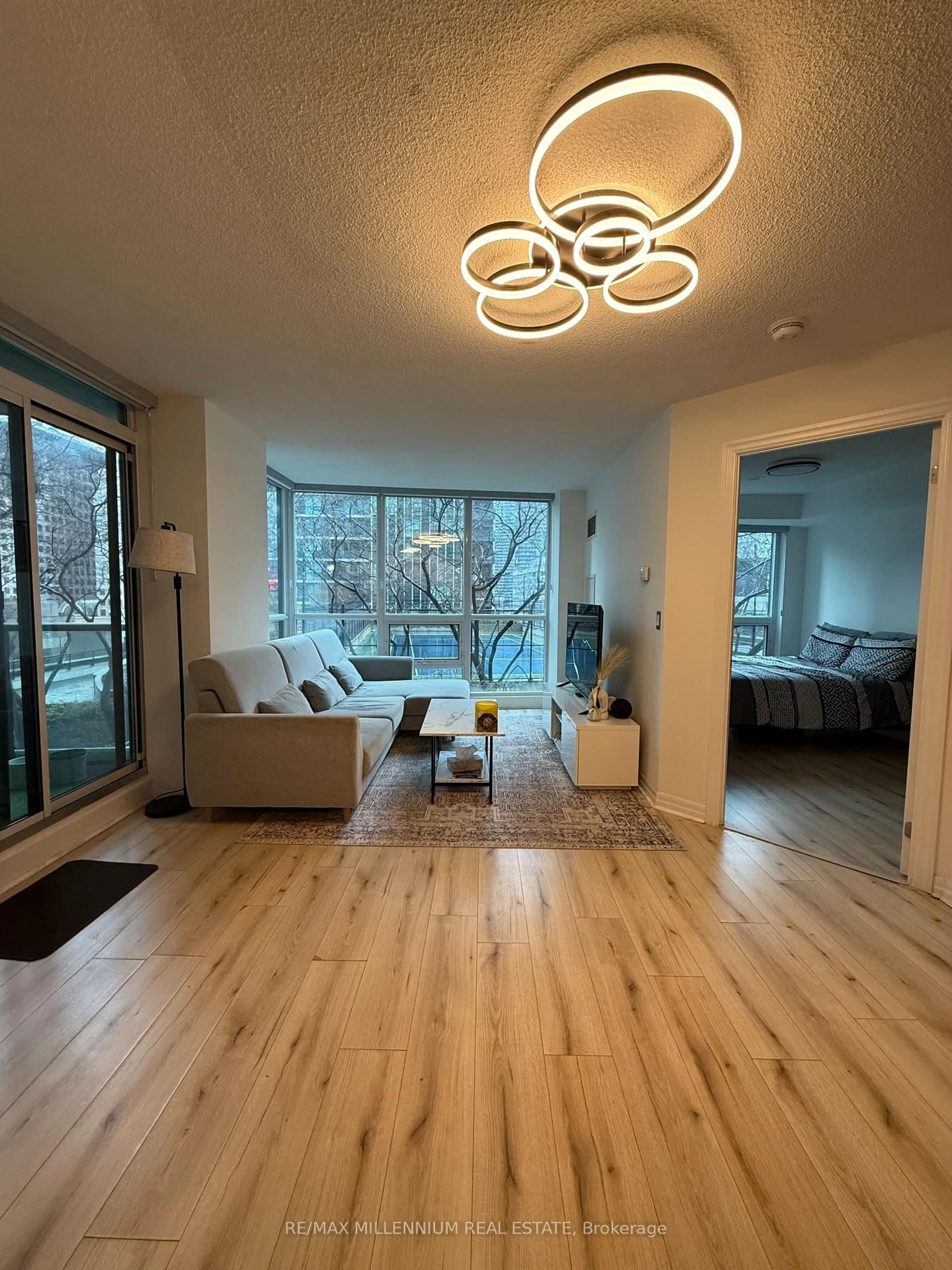 Living room with furniture, wood/laminate floor for 16 Yonge St #601, Toronto Ontario M5E 2A1