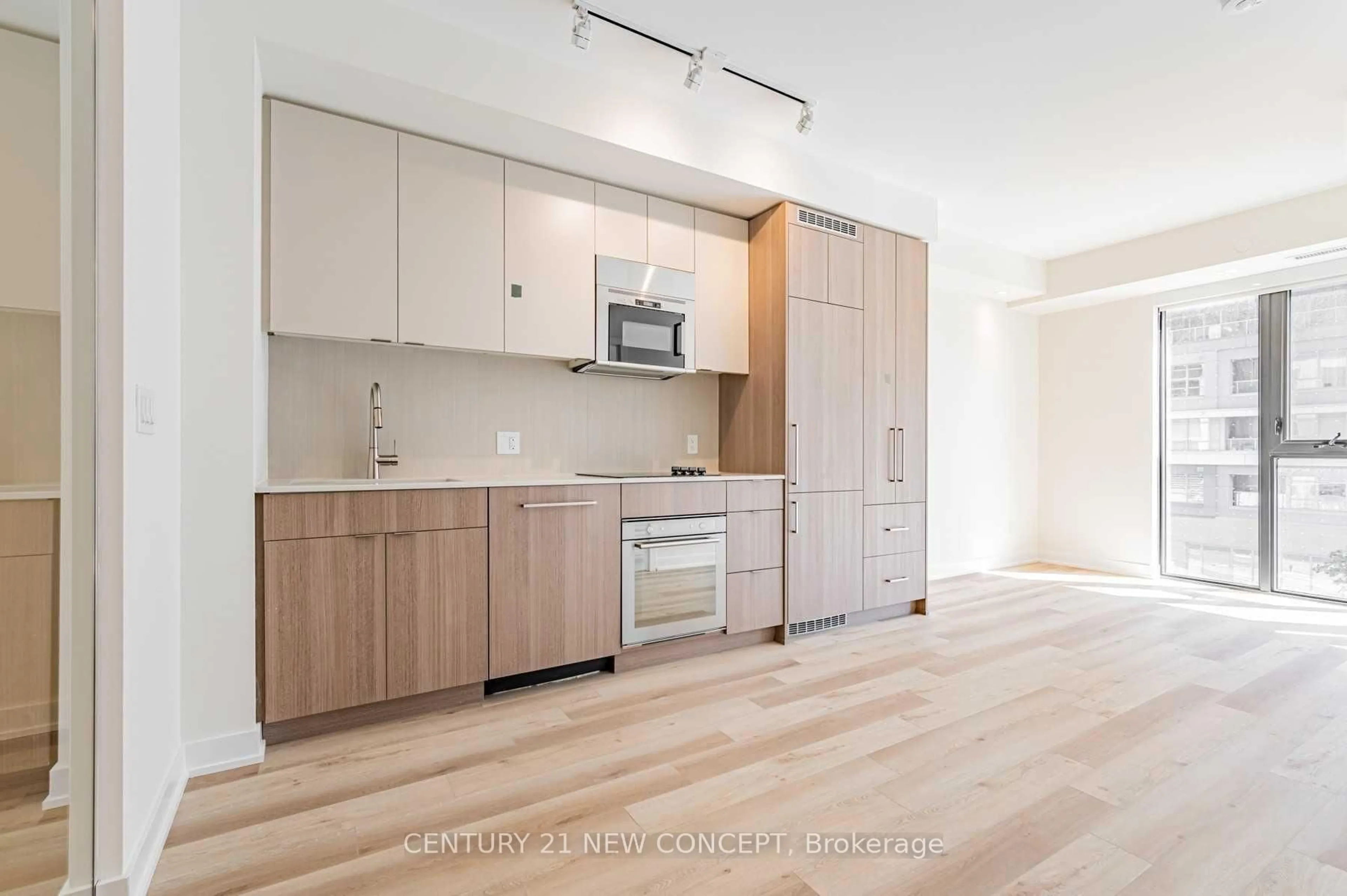 Open concept kitchen, wood/laminate floor for 840 St Clair Ave #409, Toronto Ontario M6C 0A4