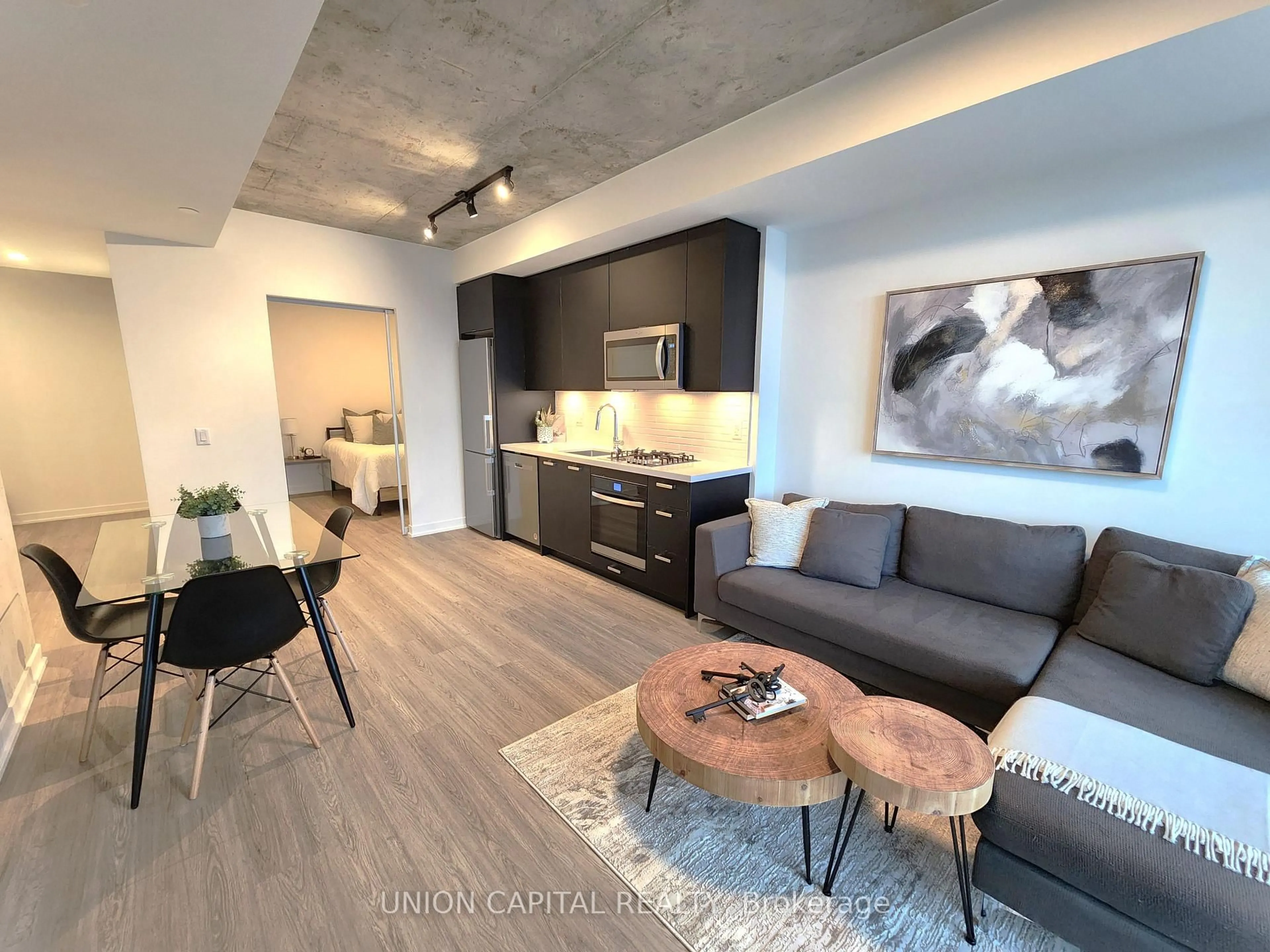 Living room with furniture, cement floor for 195 McCaul St #1601, Toronto Ontario M5T 1W6