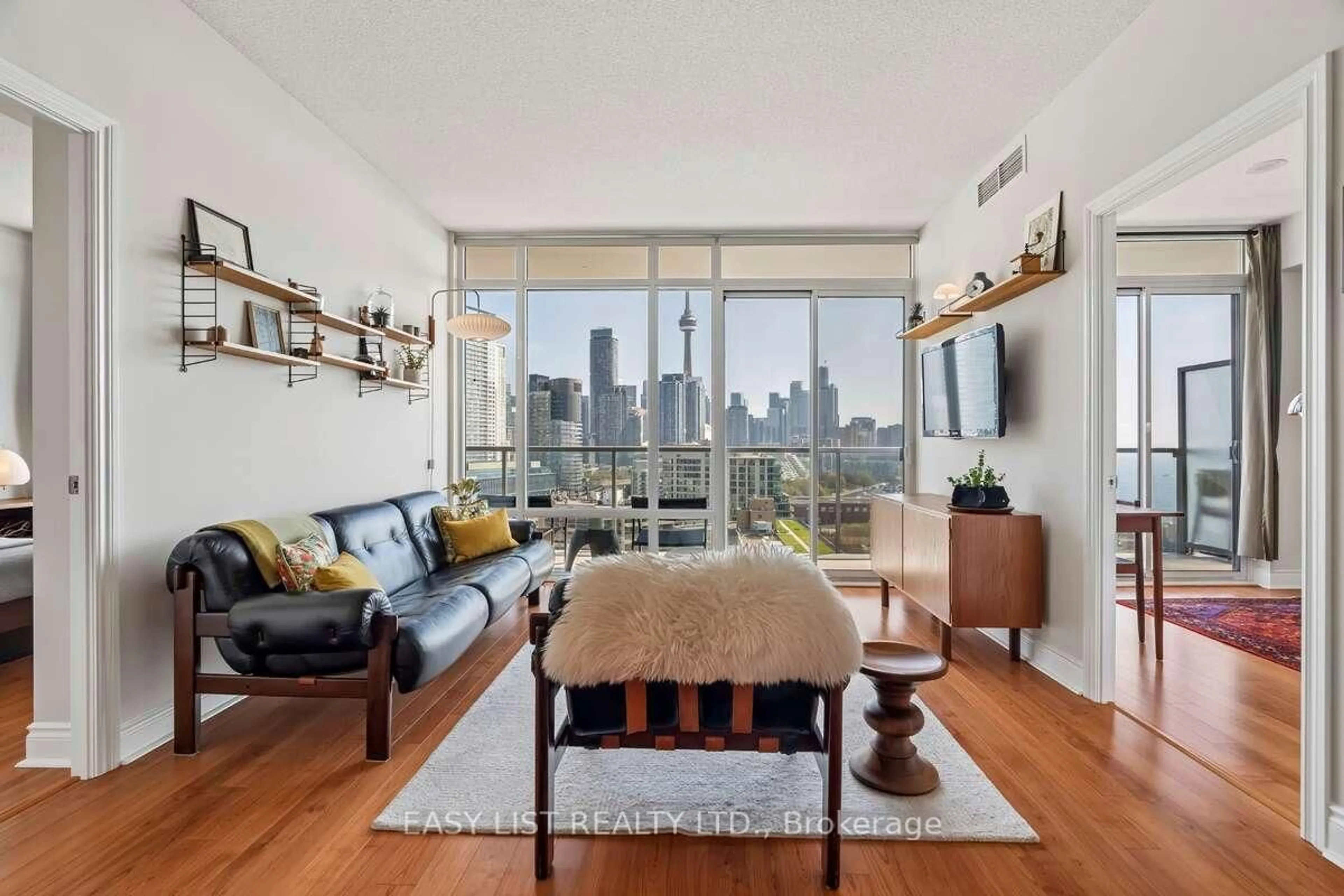 Living room with furniture, wood/laminate floor for 90 Stadium Rd #1701, Toronto Ontario M5V 3W5