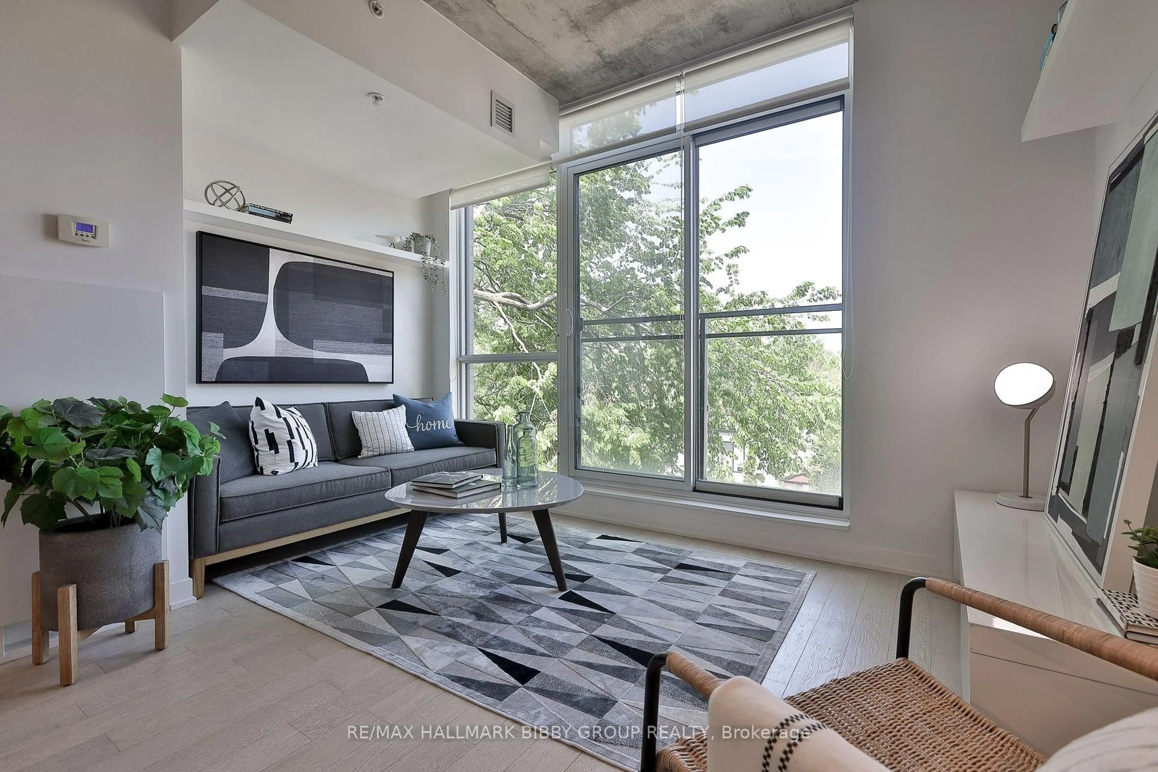 Living room with furniture, cement floor for 130 Rusholme Rd #309, Toronto Ontario M6H 1A7