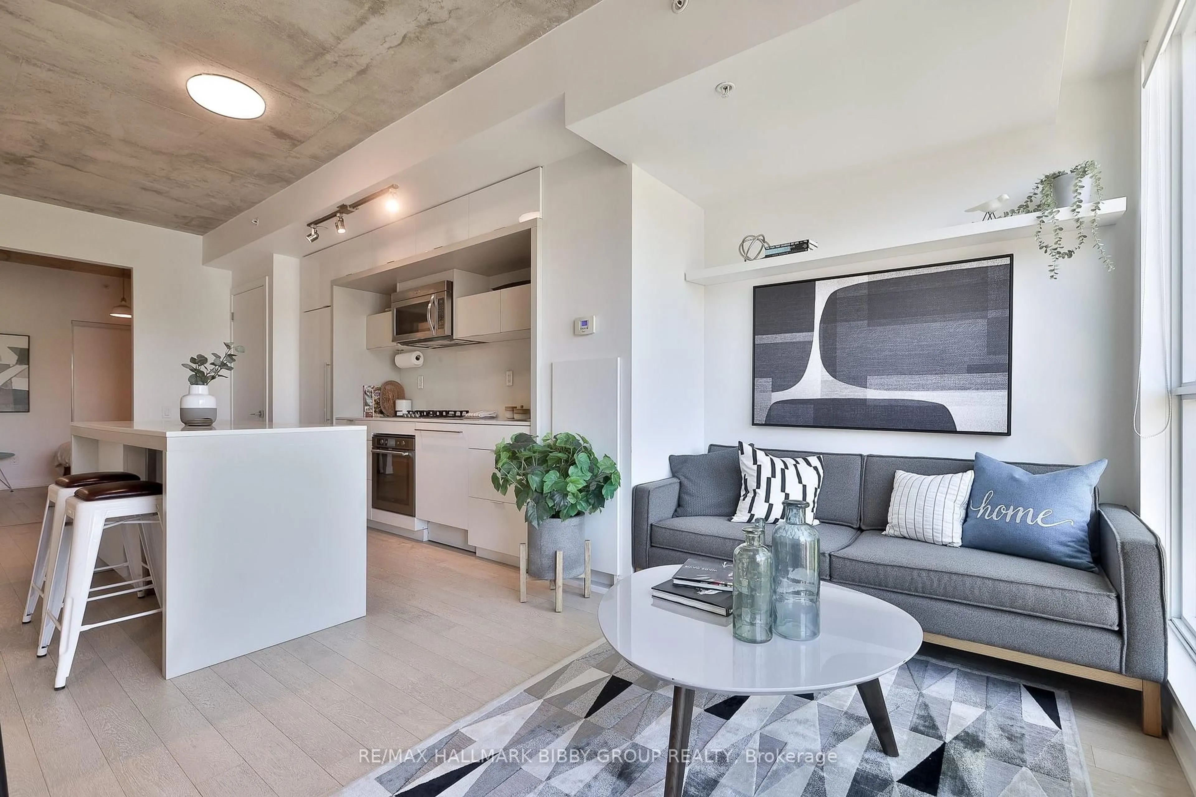 Living room with furniture, cement floor for 130 Rusholme Rd #309, Toronto Ontario M6H 1A7
