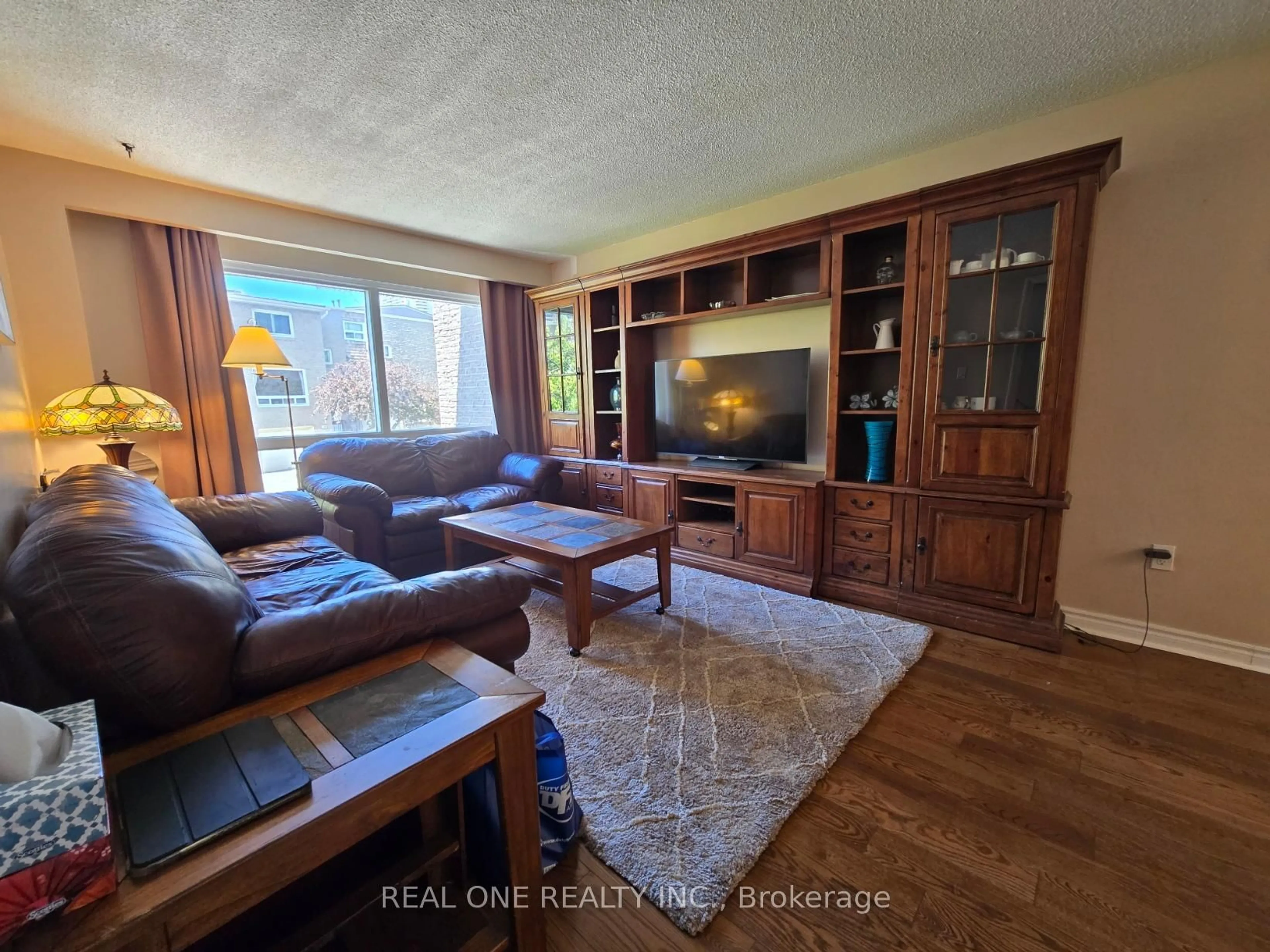 Living room with furniture, wood/laminate floor for 174 Rusty Crestway, Toronto Ontario M2J 2Y6