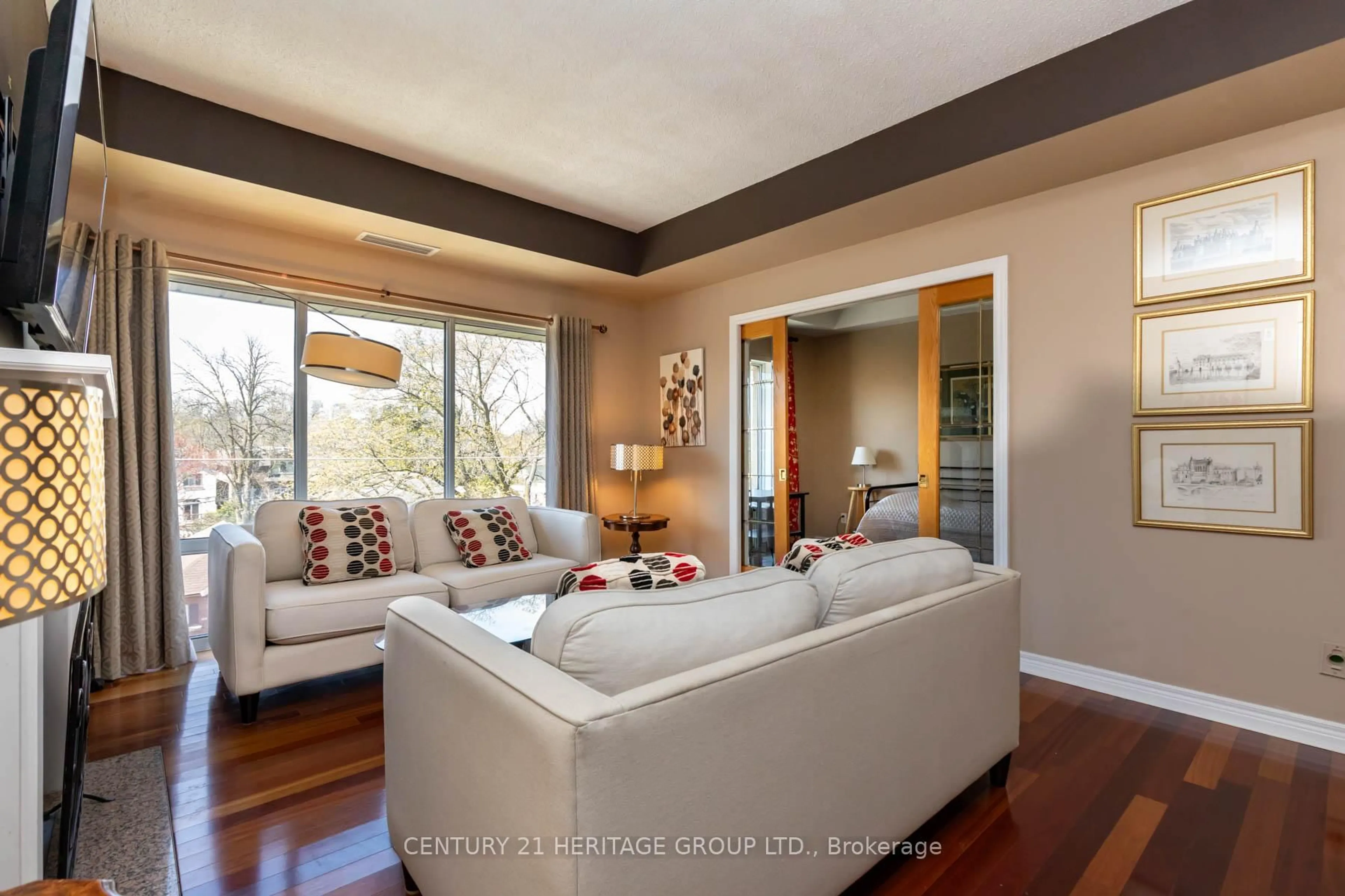 Living room with furniture, wood/laminate floor for 211 Randolph Rd #405, Toronto Ontario M4G 4H1