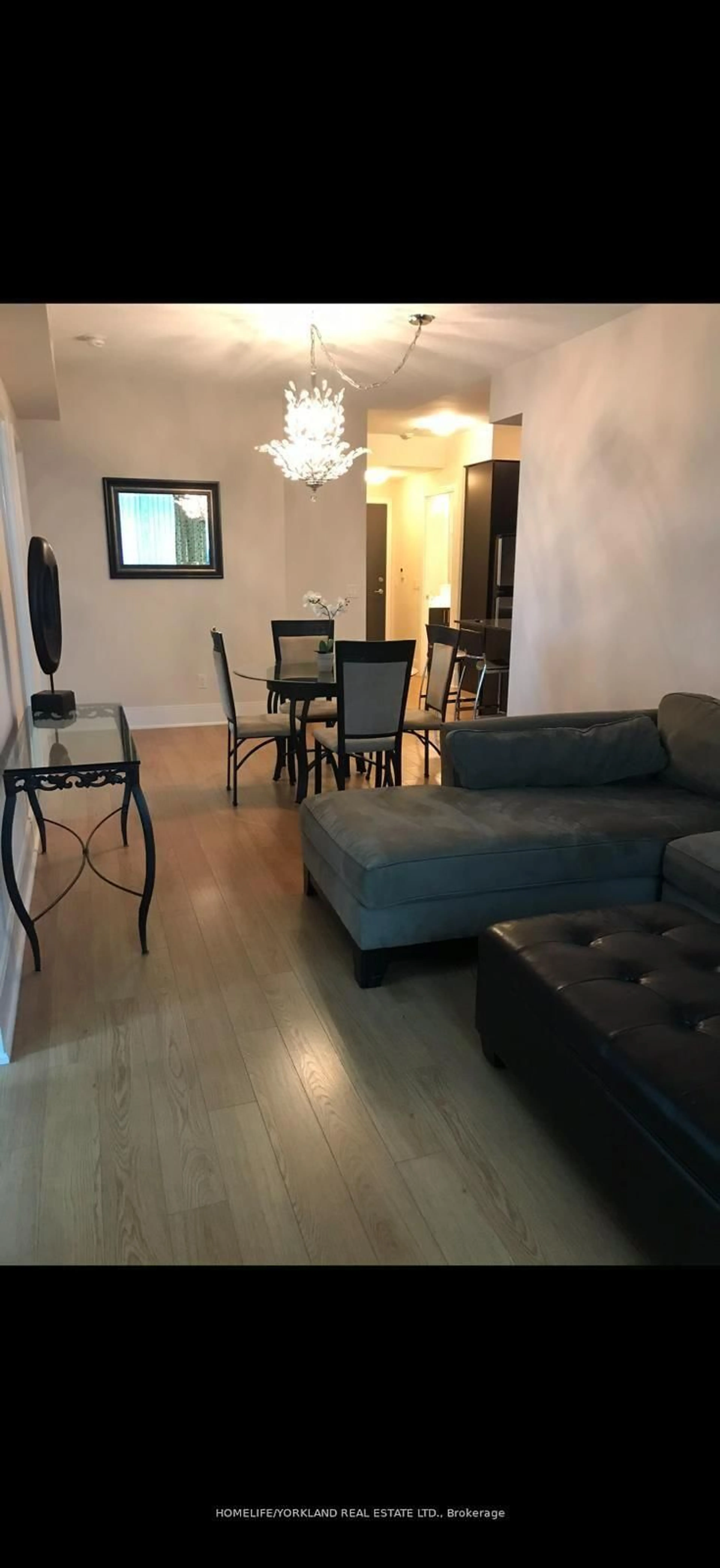Living room with furniture, wood/laminate floor for 181 Wynford Dr #411, Toronto Ontario M3C 0C6