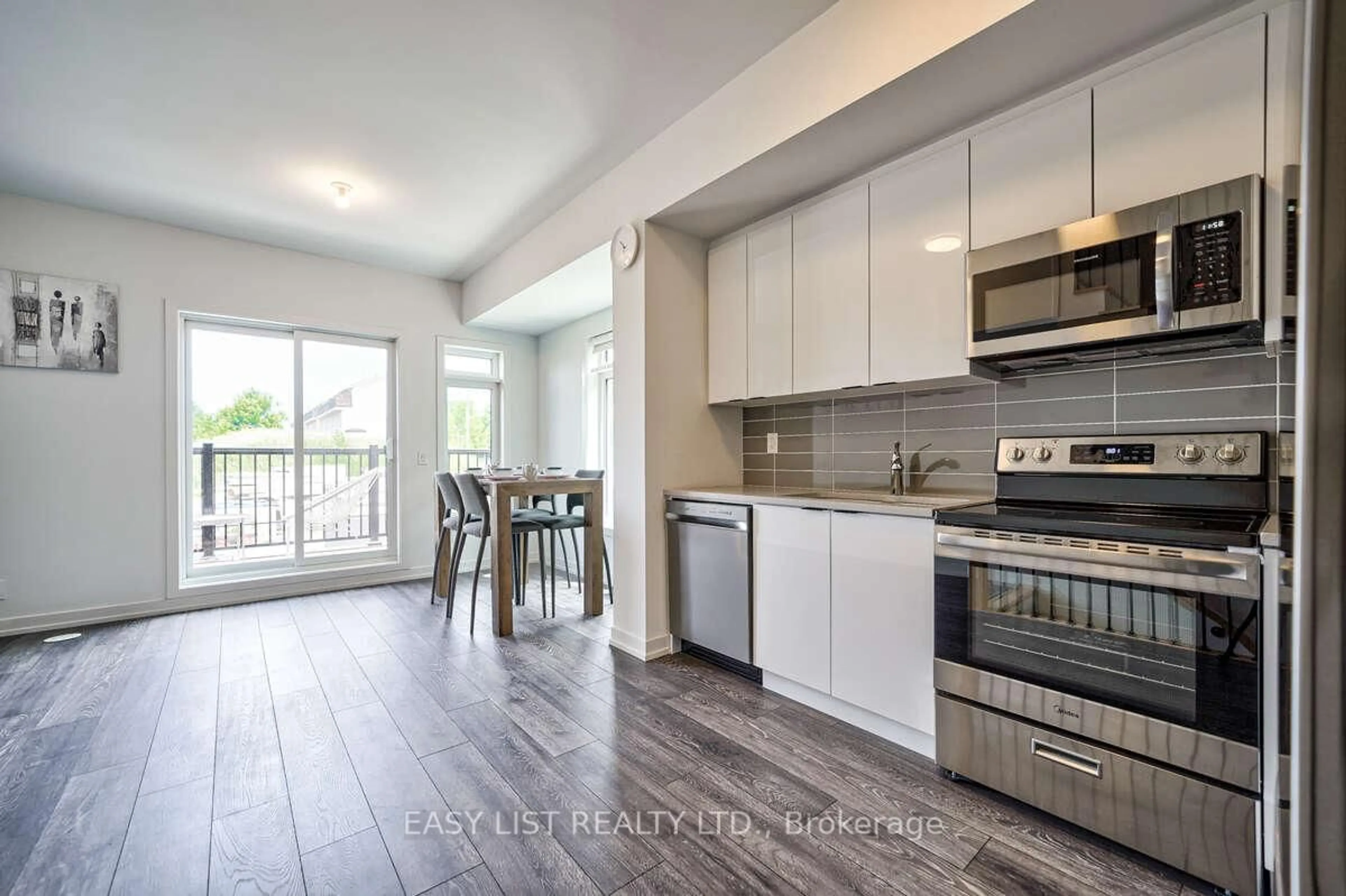 Open concept kitchen, wood/laminate floor for 27 Spruce Pines Cres, Toronto Ontario M4A 0A9