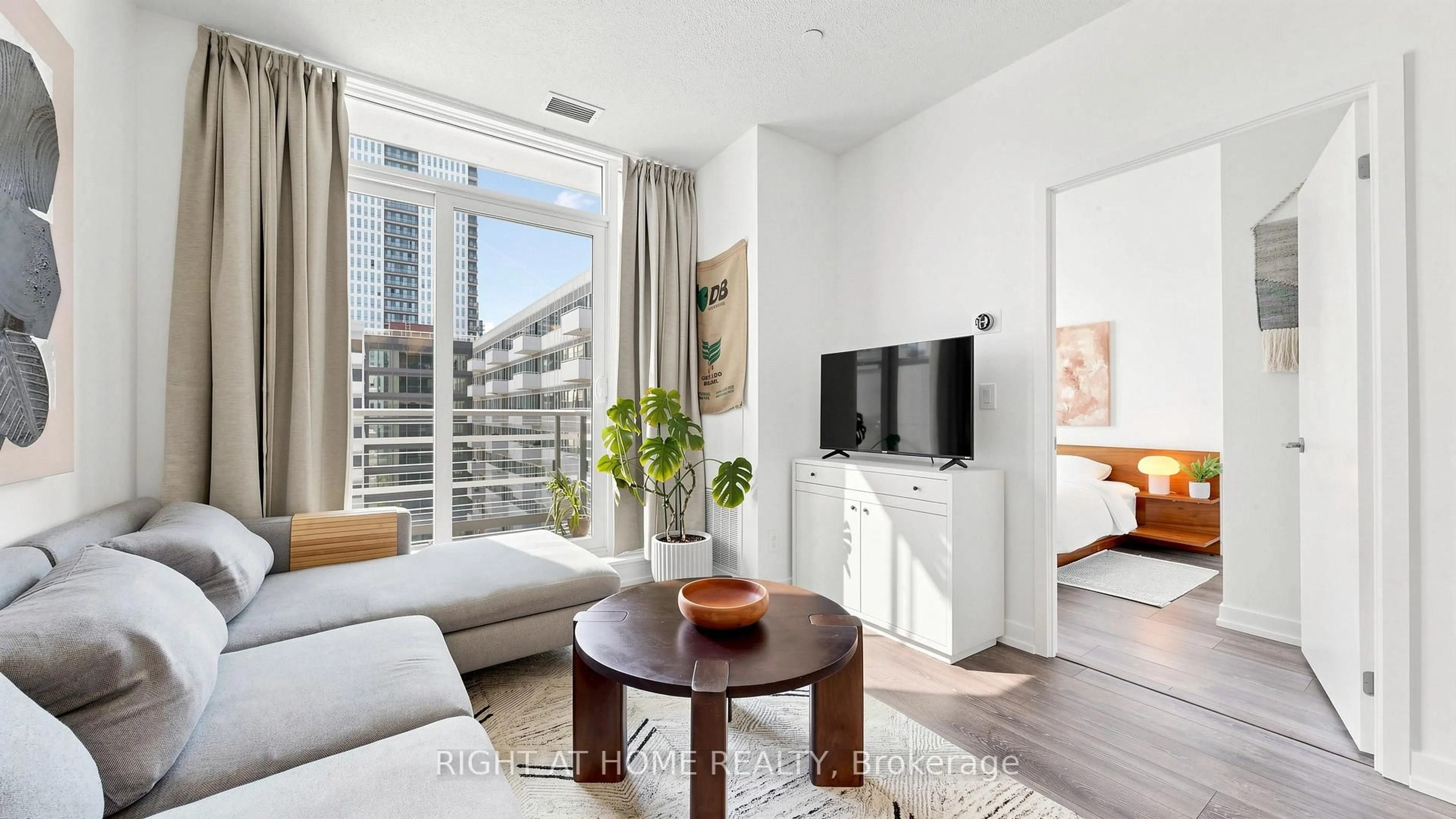 Living room with furniture, wood/laminate floor for 200 Sackville St #714, Toronto Ontario M5A 0C4