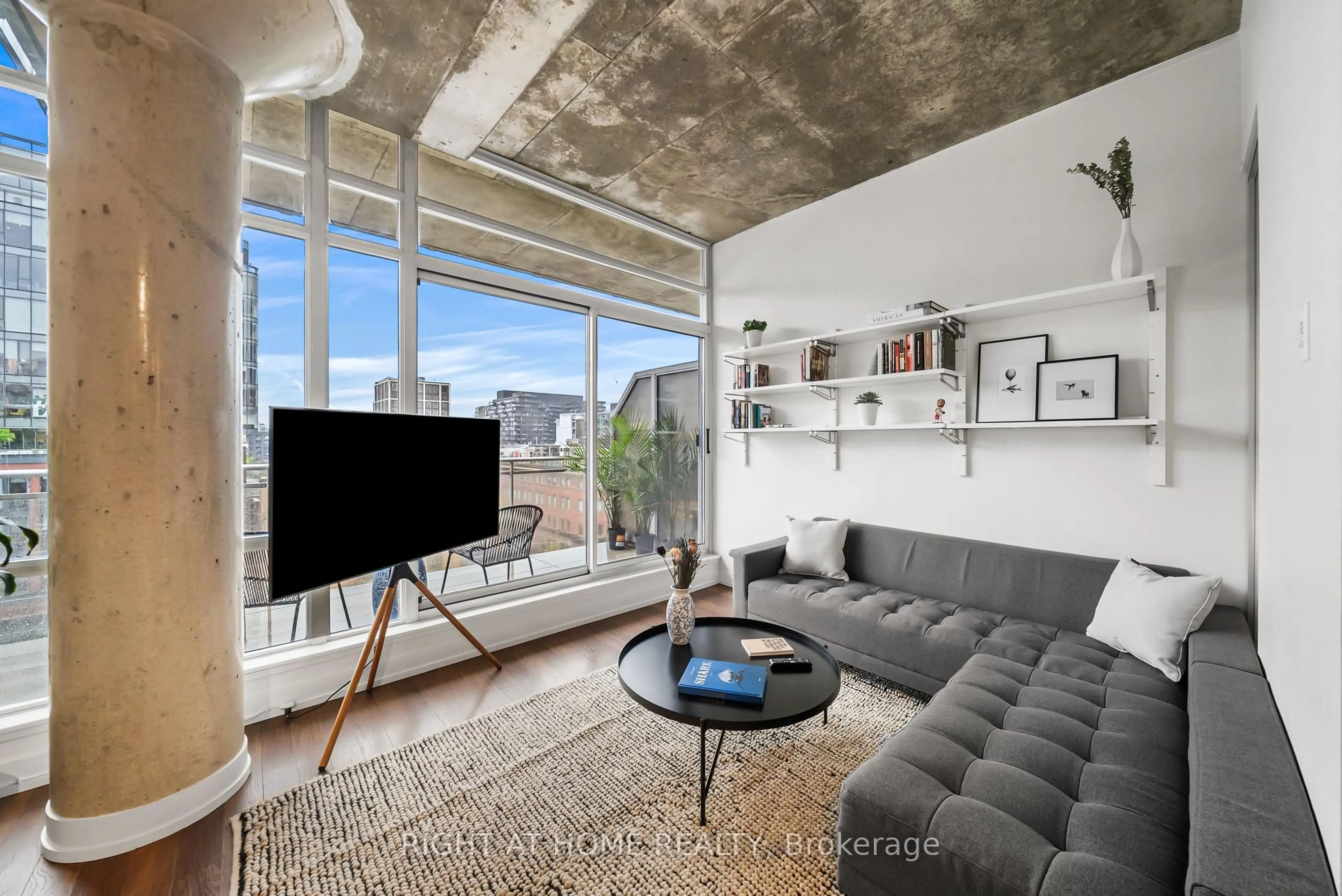 Living room with furniture, cement floor for 66 Portland St #807, Toronto Ontario M5V 2M6