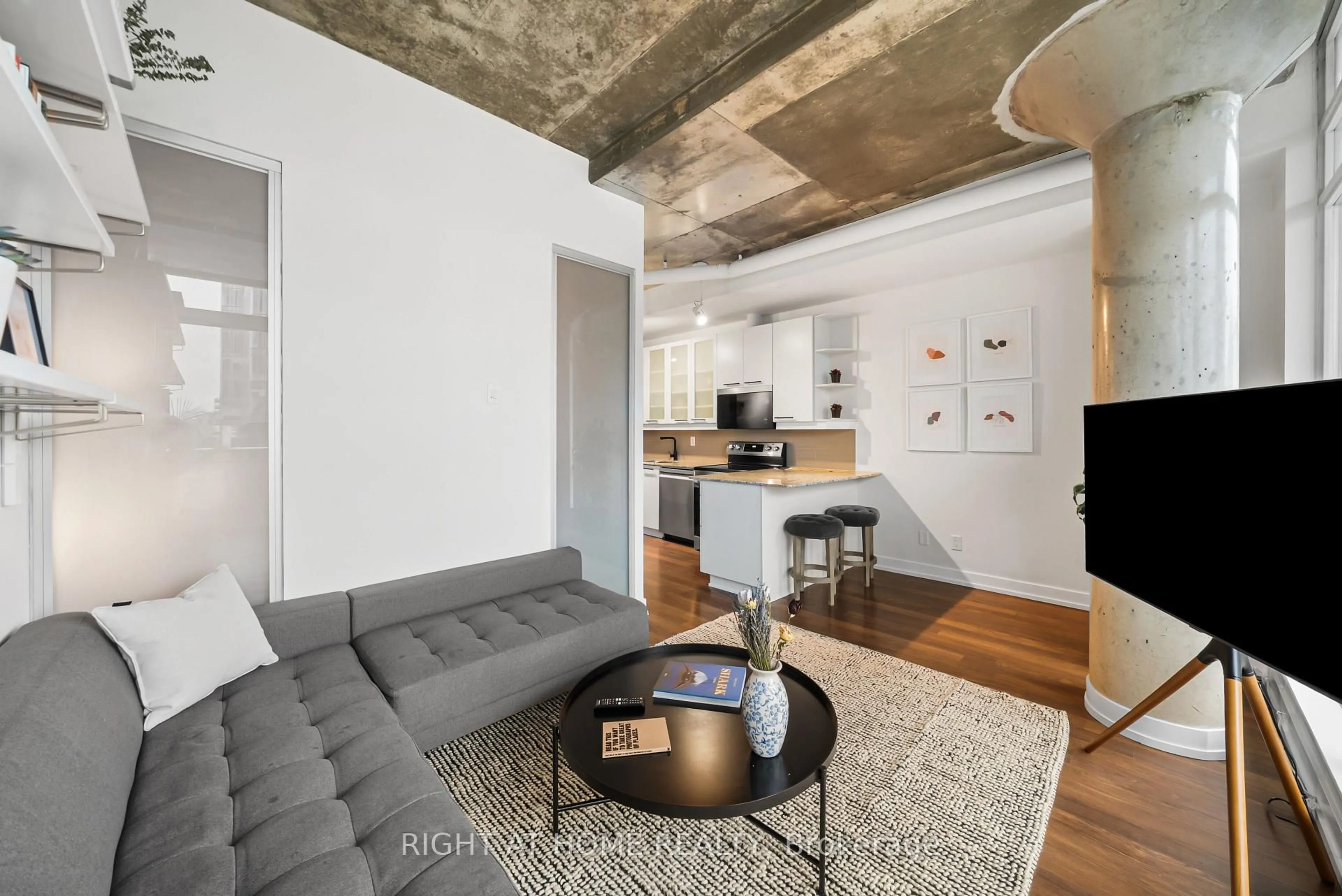 Living room with furniture, cement floor for 66 Portland St #807, Toronto Ontario M5V 2M6