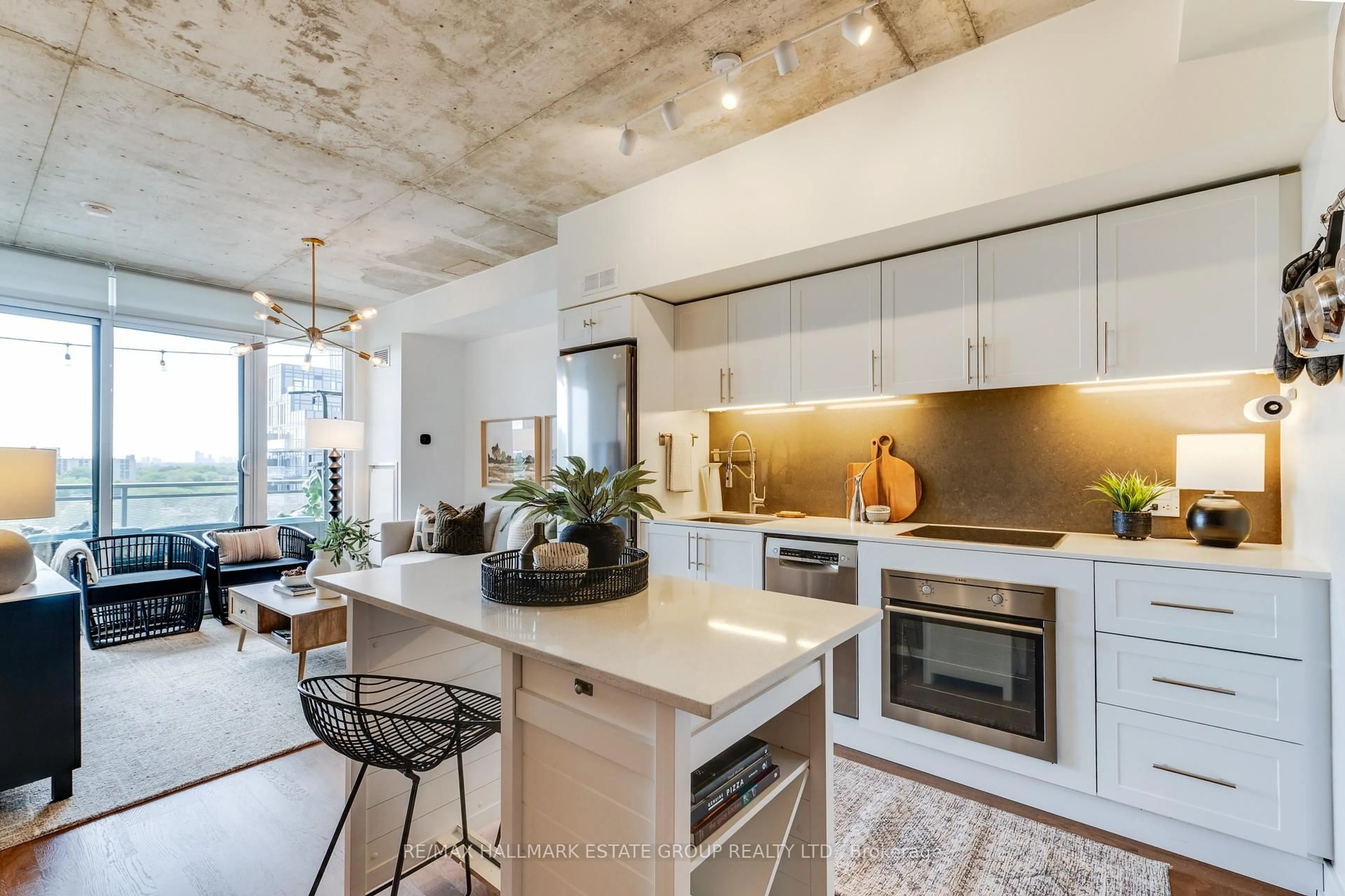 Open concept kitchen, cement floor for 20 Minowan Miikan Lane #1018, Toronto Ontario M6J 0E5