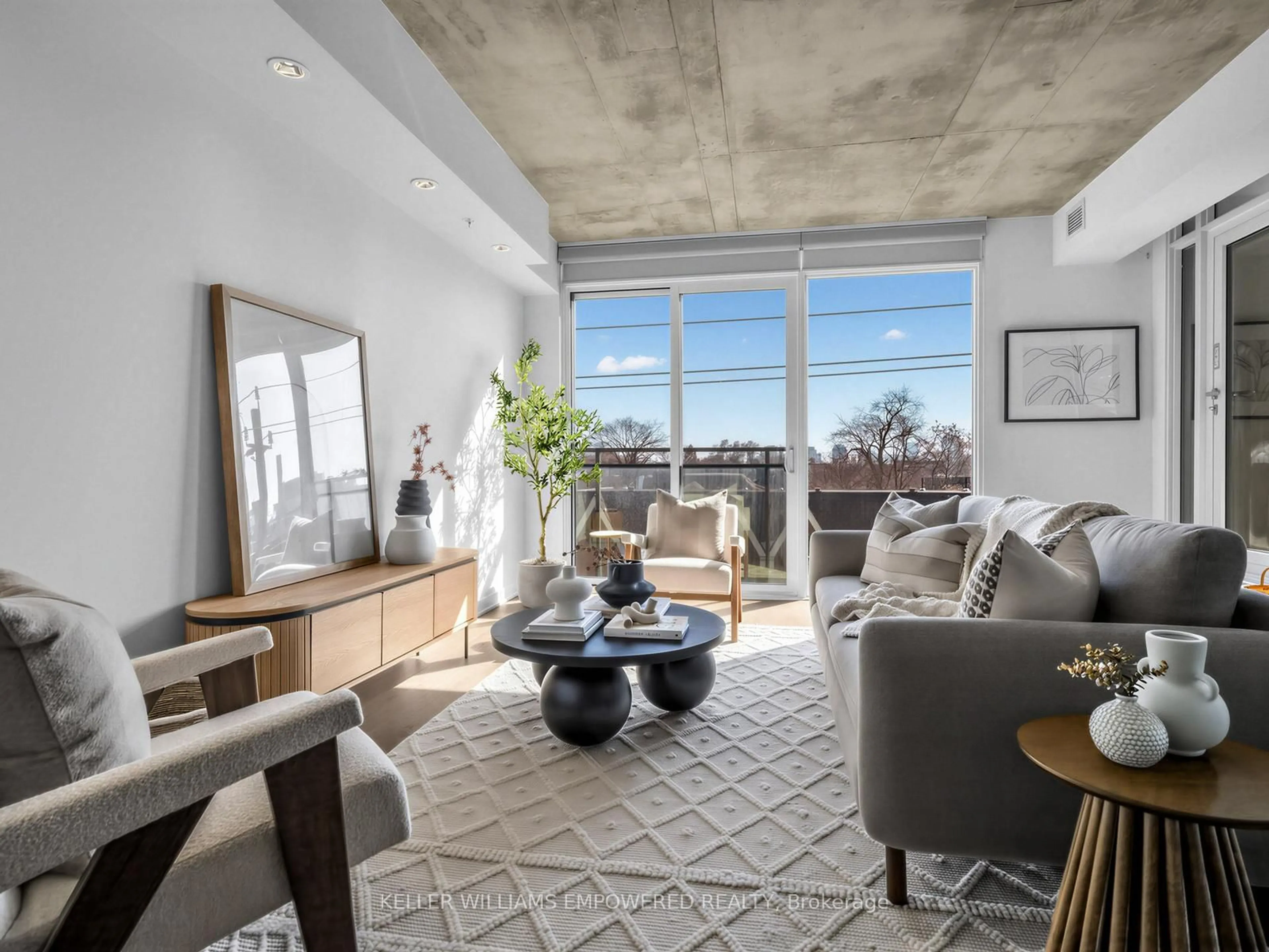 Living room with furniture, cement floor for 130 Rusholme Rd #406, Toronto Ontario M6H 1A7